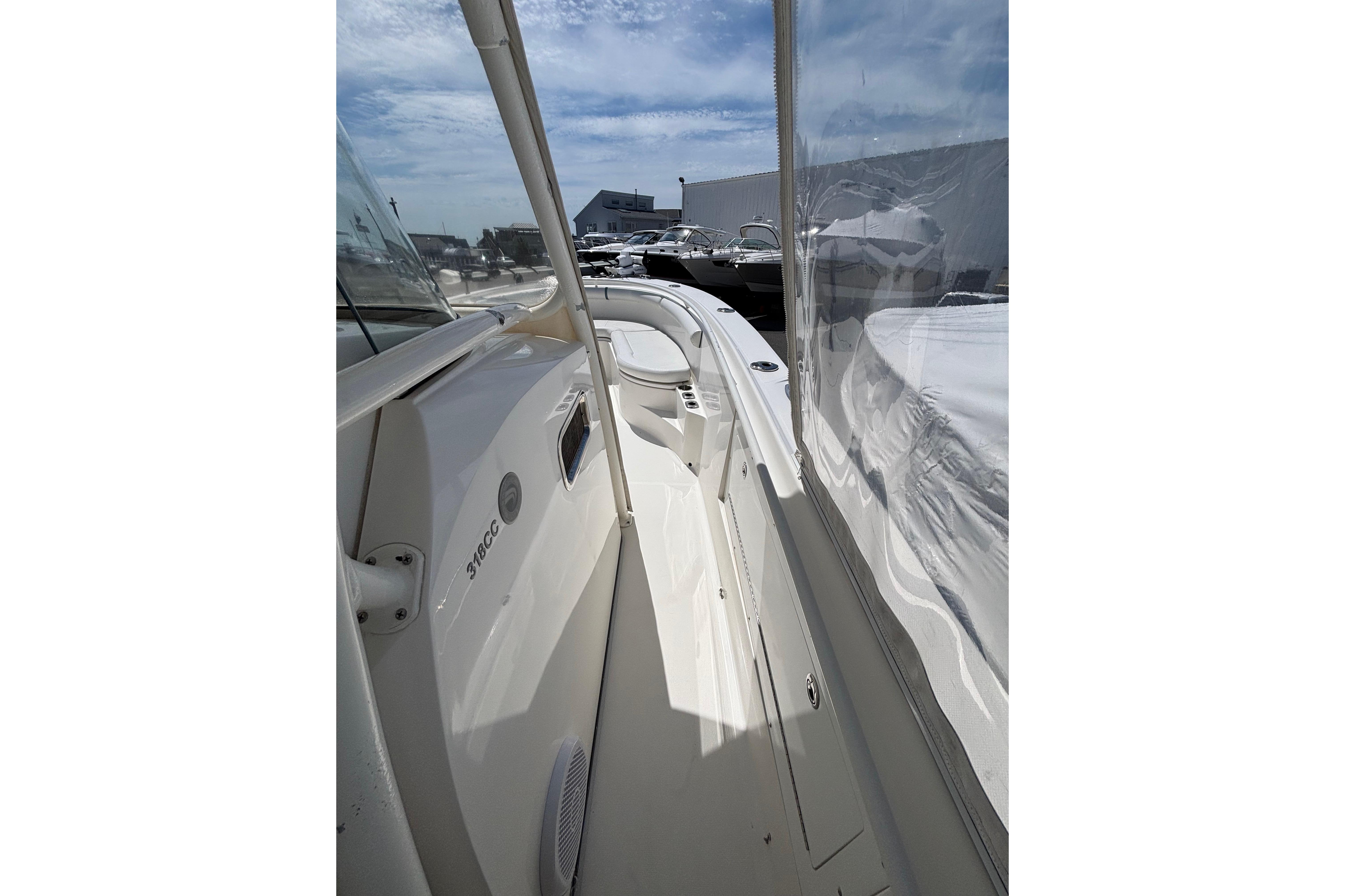 2006 Edgewater 318CC boat deck with clear skies and marina background.