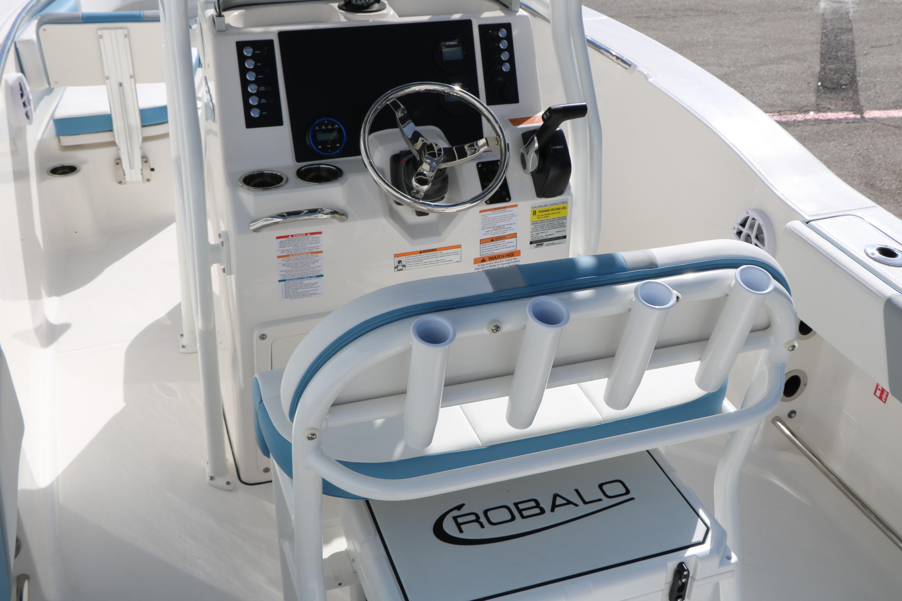 2026 Robalo R200 Center Console boat interior with steering wheel and rod holders.