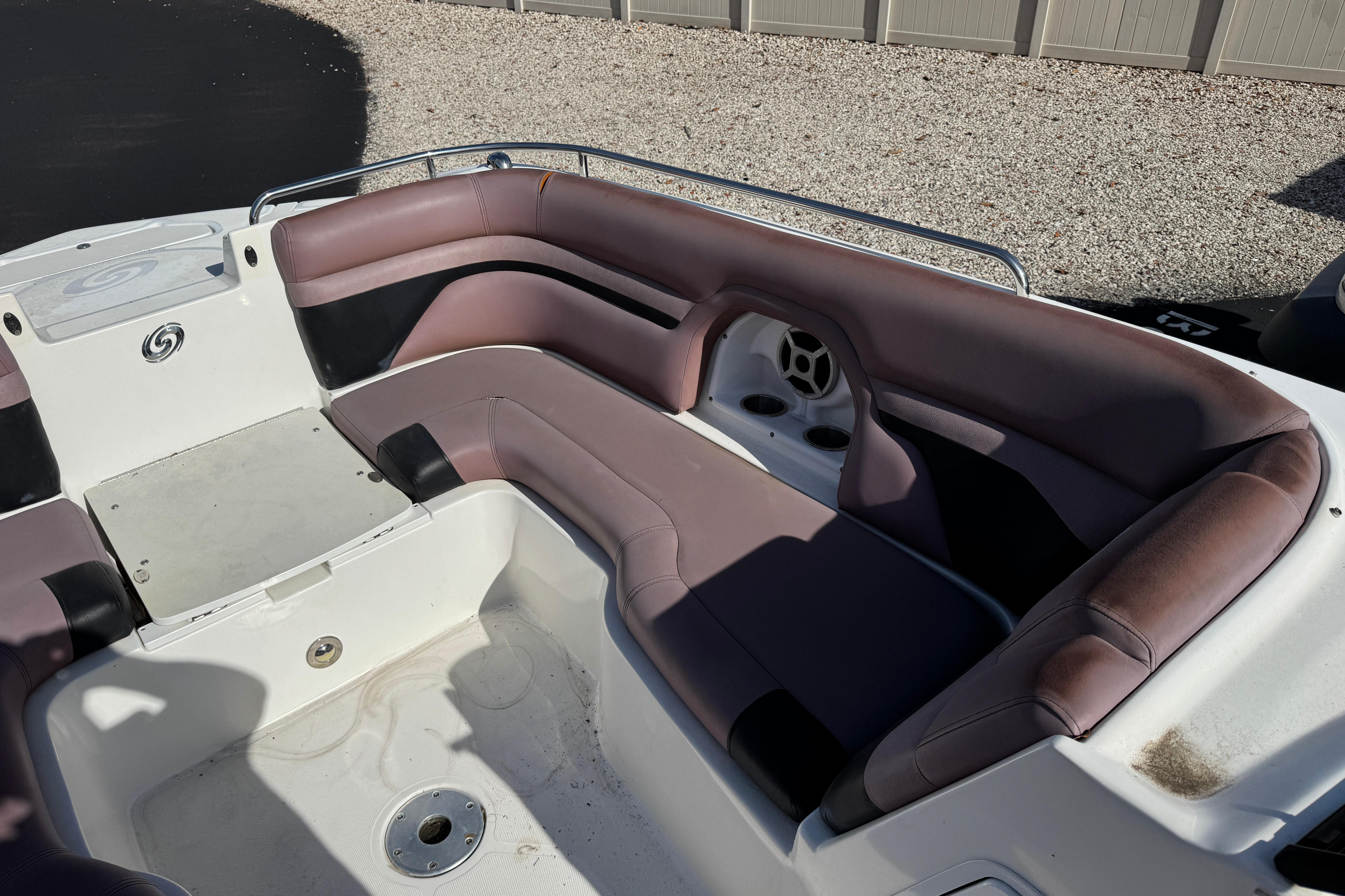 2018 Hurricane SunDeck 2400 OB boat interior with spacious seating and cup holders.