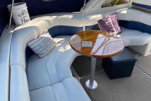 Luxurious 1994 Cruisers Yachts 3675 Esprit interior with plush seating and wooden table.