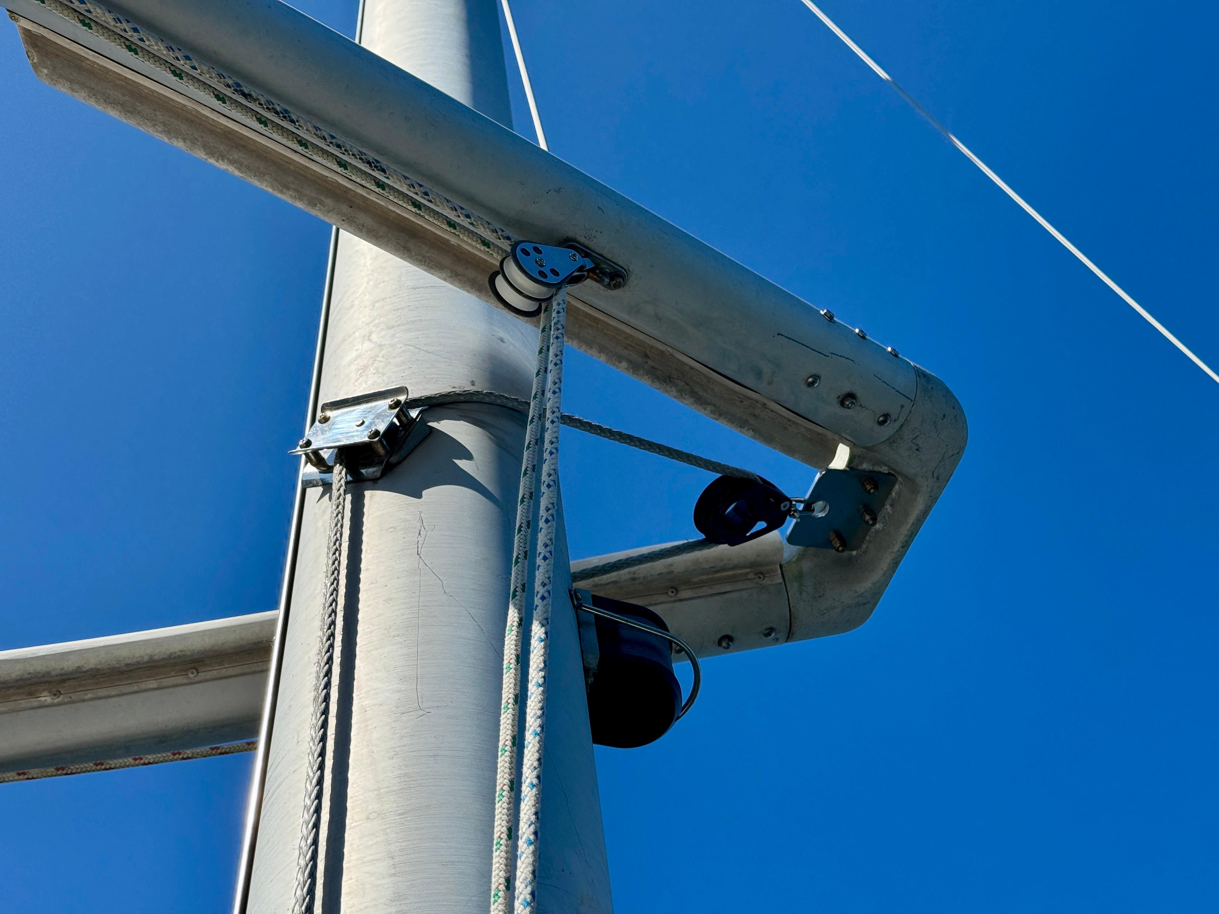 Mast and rigging of 1989 Nonsuch 30 Ultra sailboat against clear blue sky.