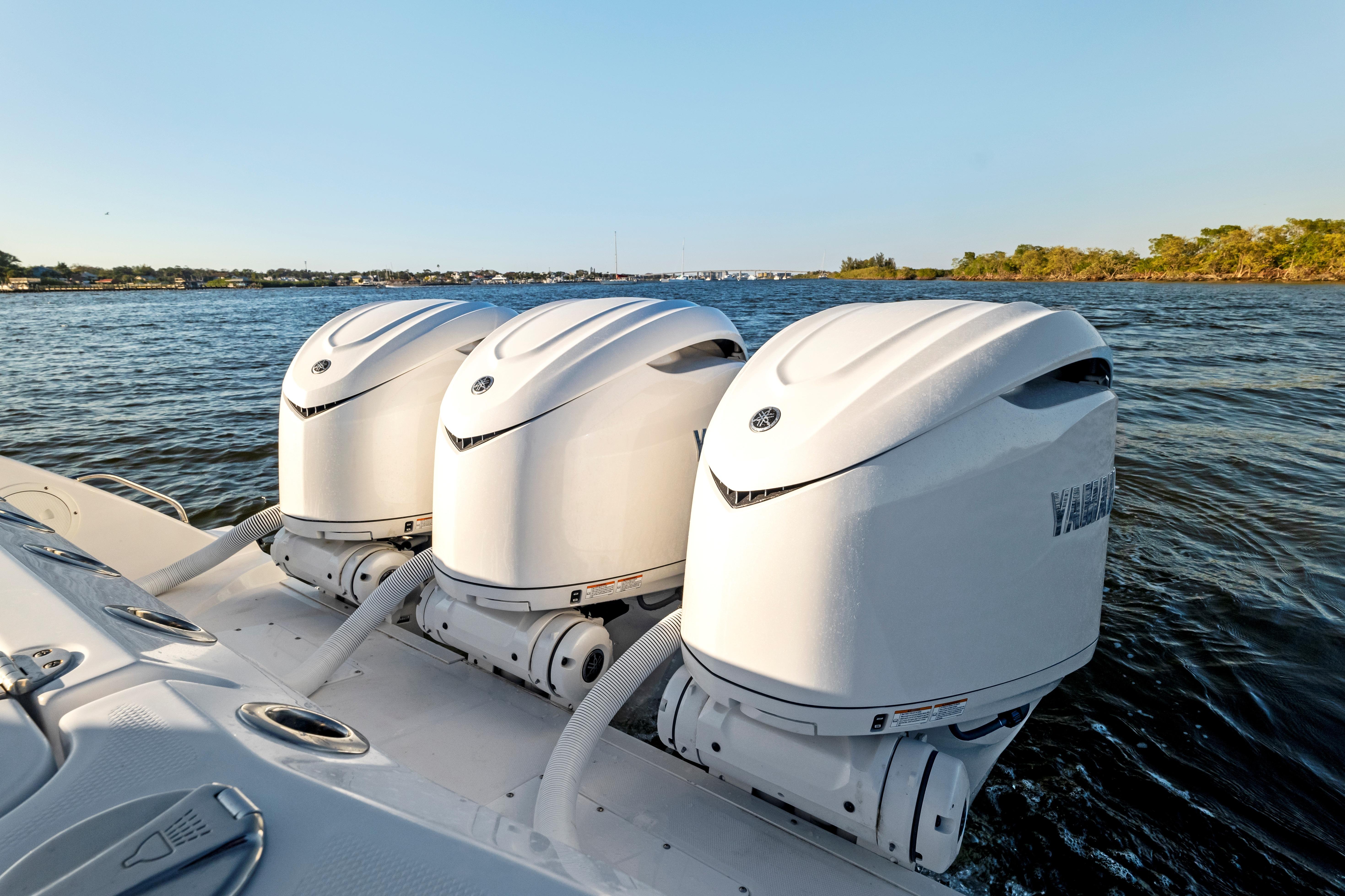 2026 Everglades 375 Center Console with triple outboard engines on water.