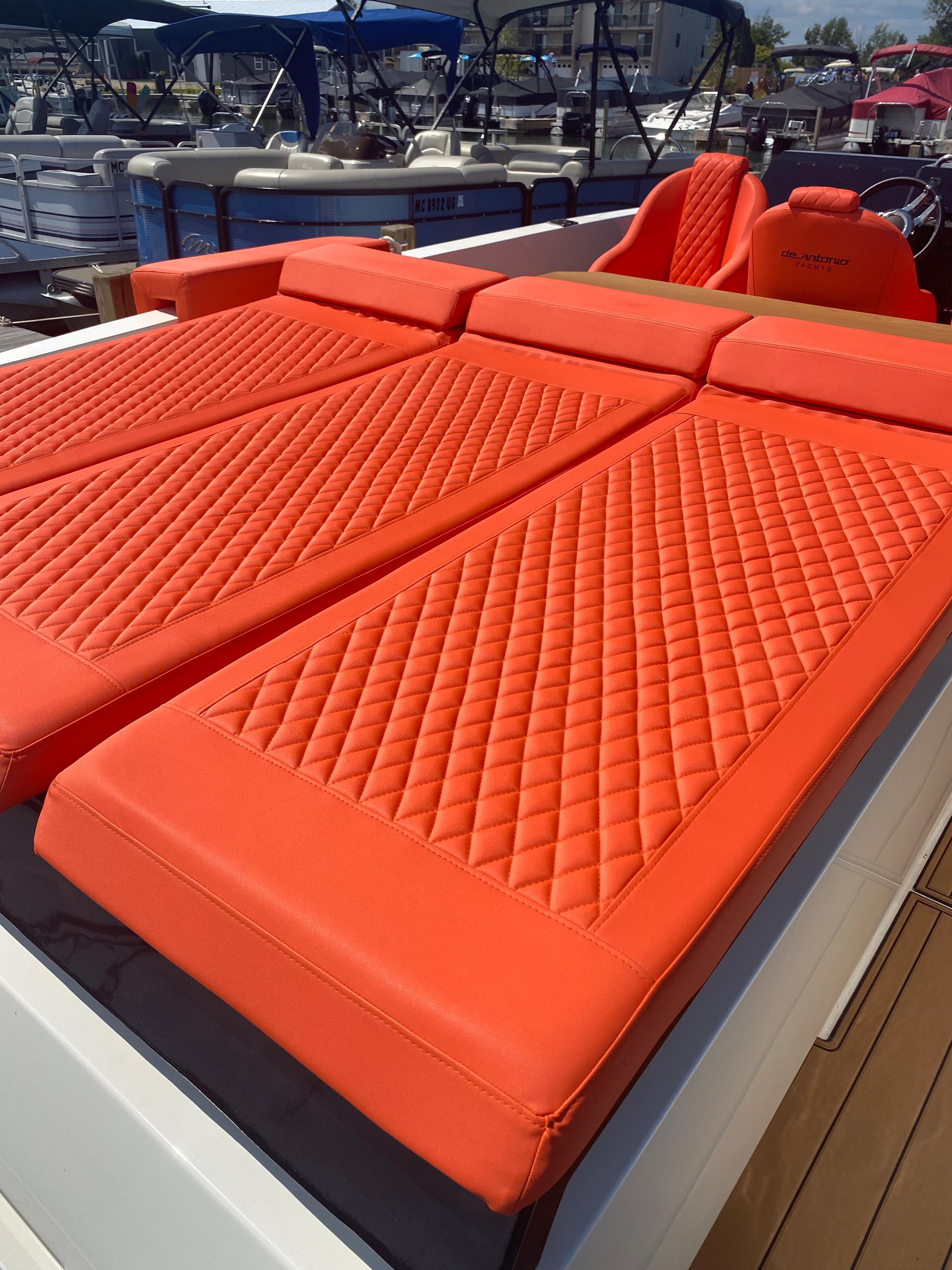 2020 De Antonio Yachts D 28 with orange quilted sunbeds.