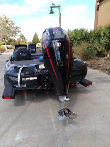 2025 Nitro Z19 boat with powerful outboard motor, parked on concrete driveway.