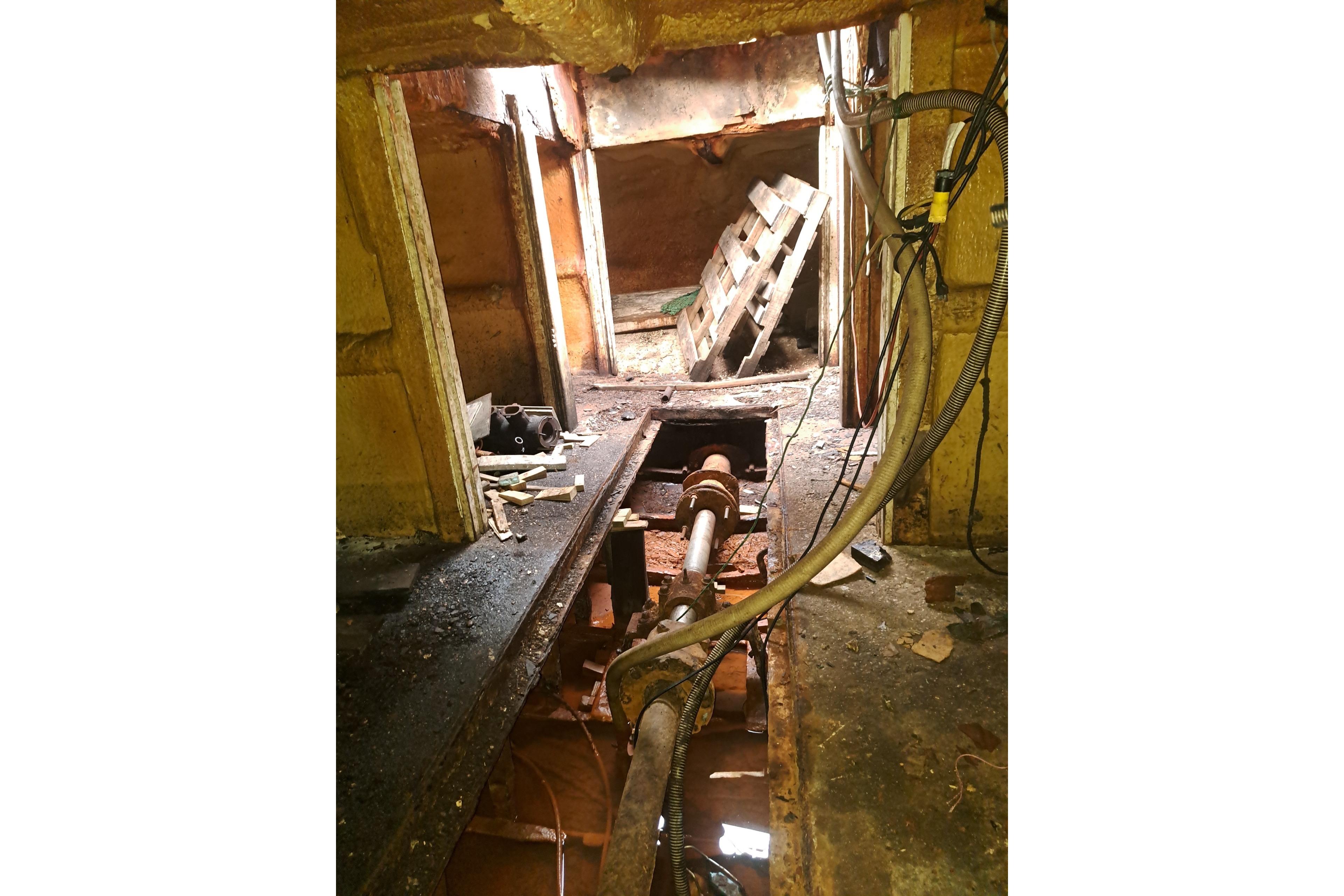 Interior of a 1979 Custom Steel Trawler Dragger, showing machinery and cables.