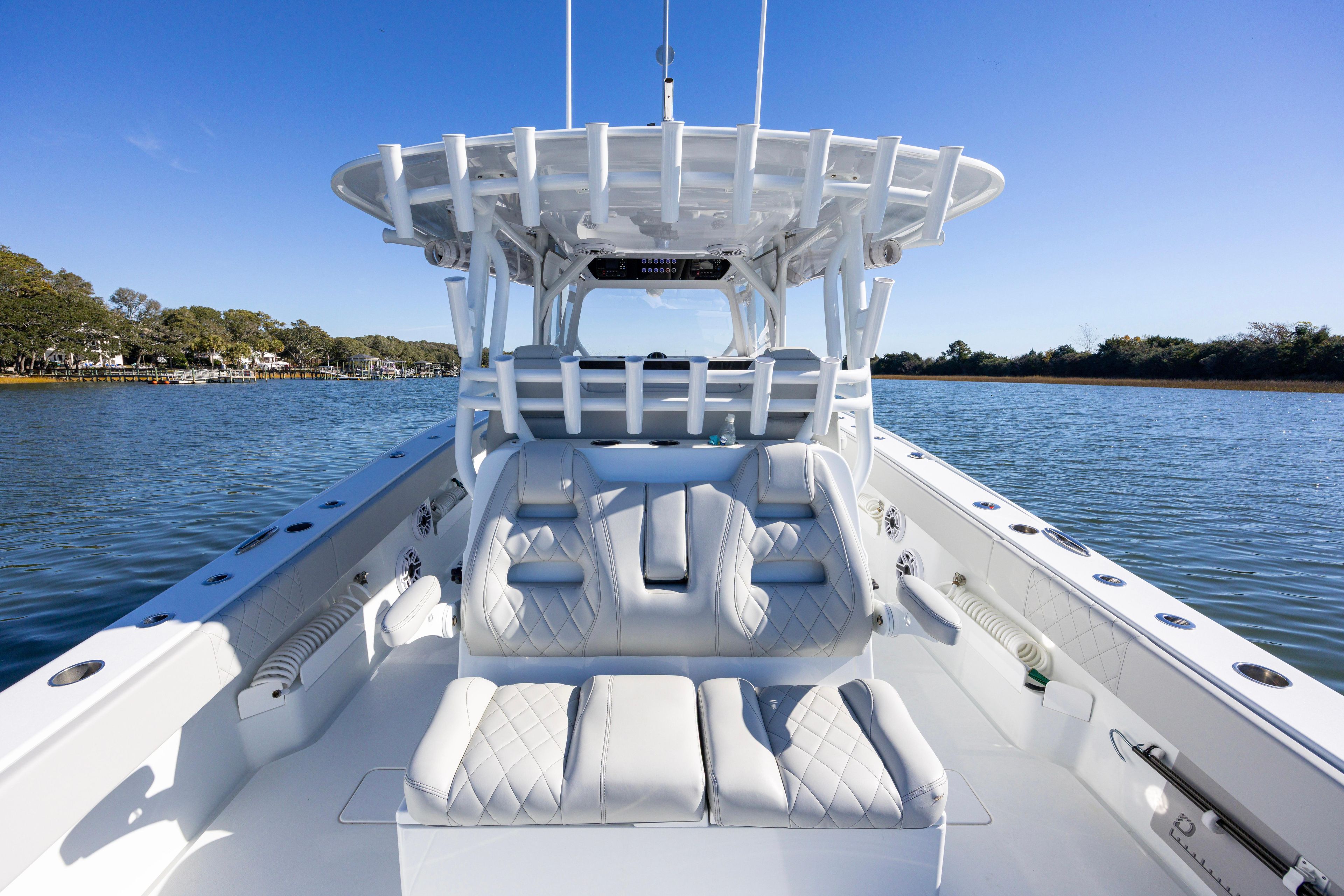 2024 Freeman 38 boat with luxurious seating on a calm waterway.