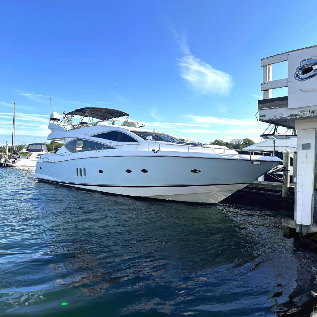 2005 Sunseeker 75 Yacht docked in a marina under clear blue skies.