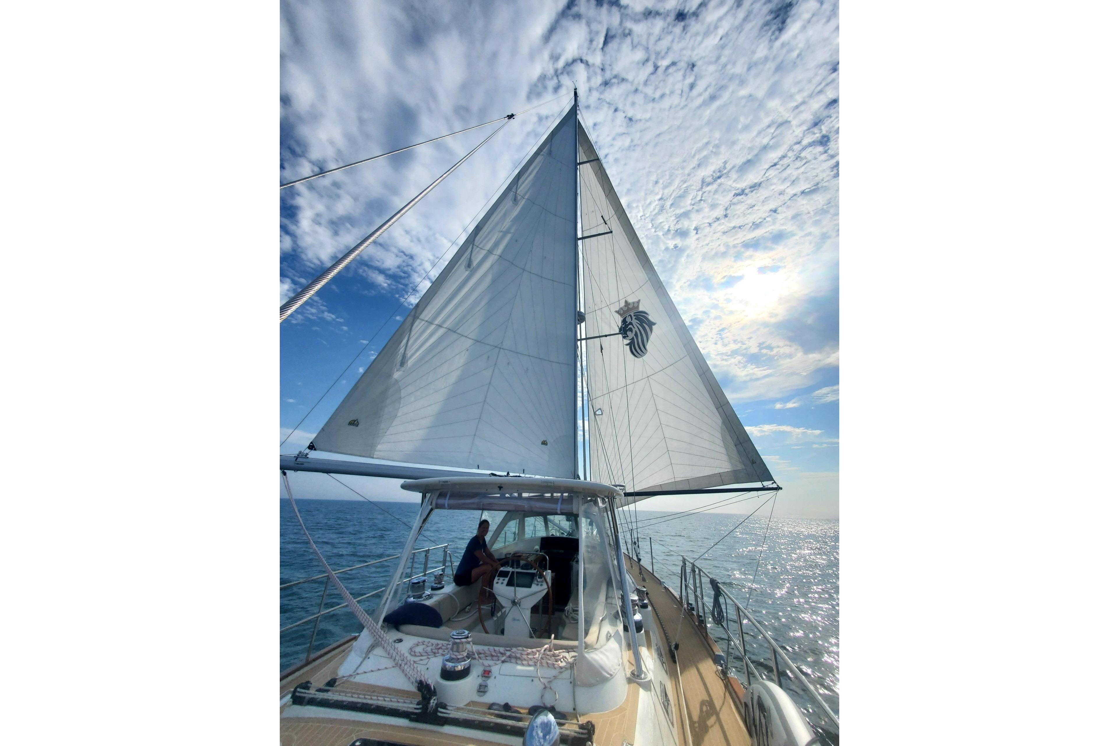2023 Bluewater 56 sailboat on open sea under a partly cloudy sky.