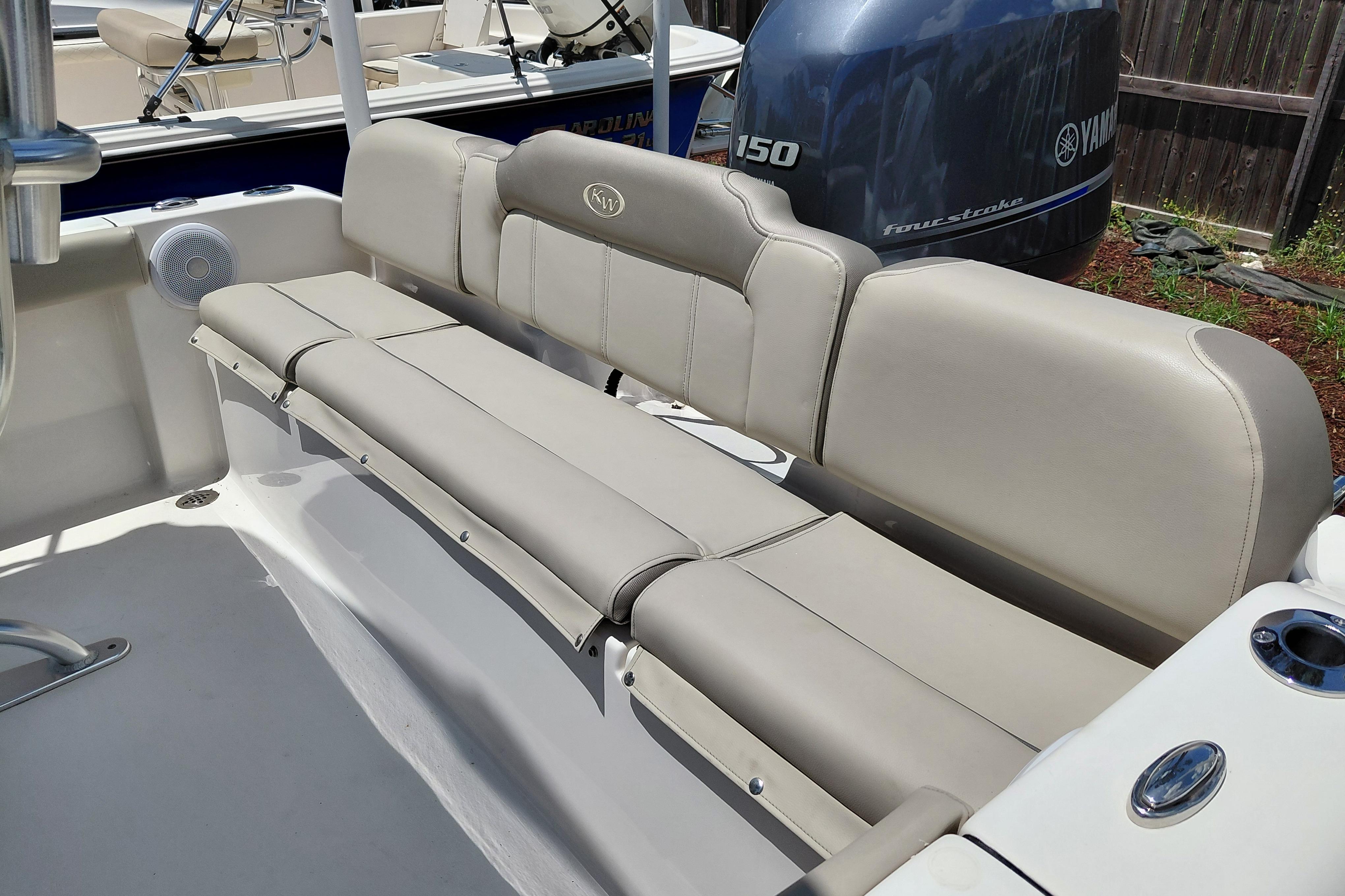 2023 Key West 189 FS boat interior with beige seating and Yamaha engine.