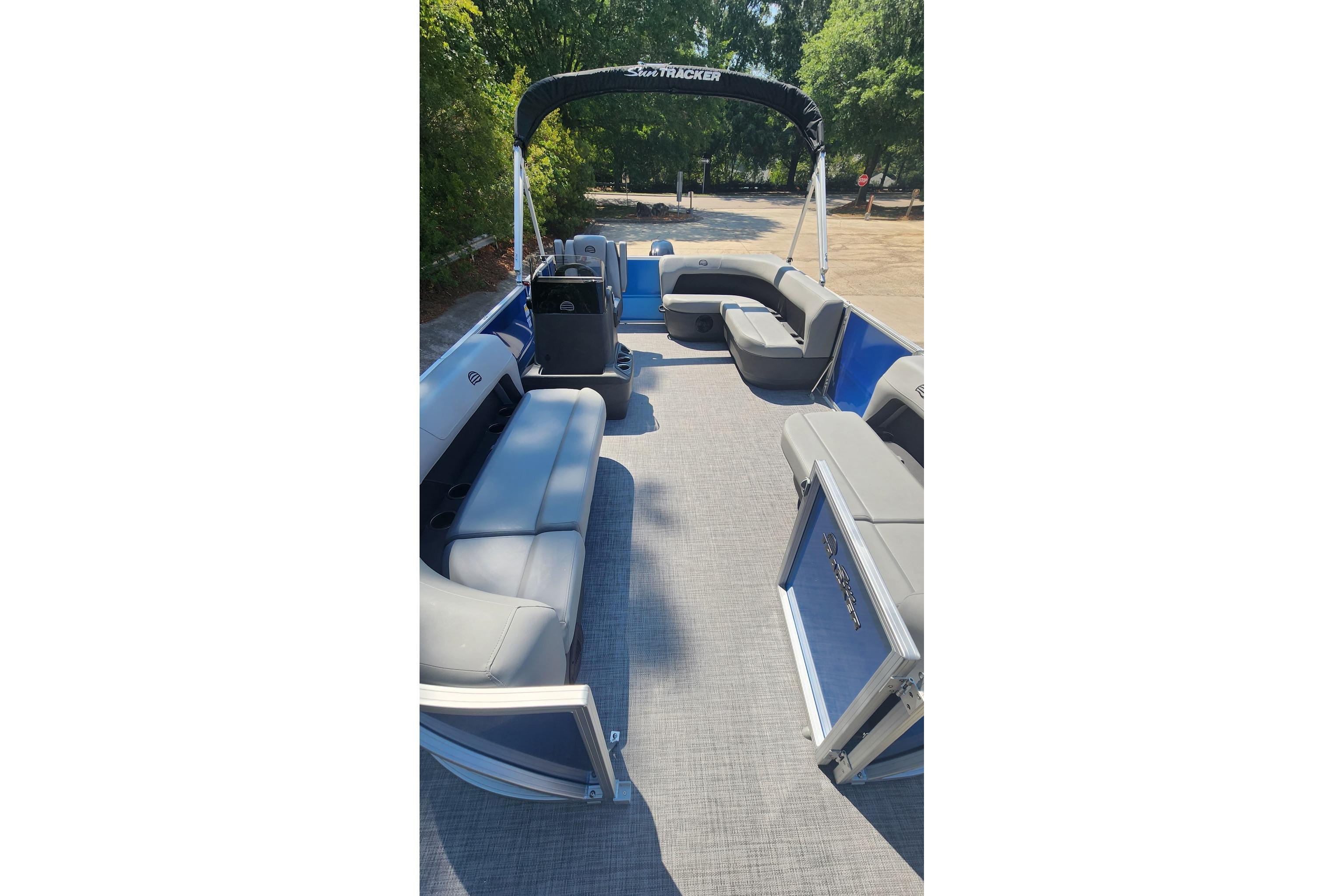 2026 Sun Tracker Party Barge 16 DLX pontoon boat with spacious seating and canopy.