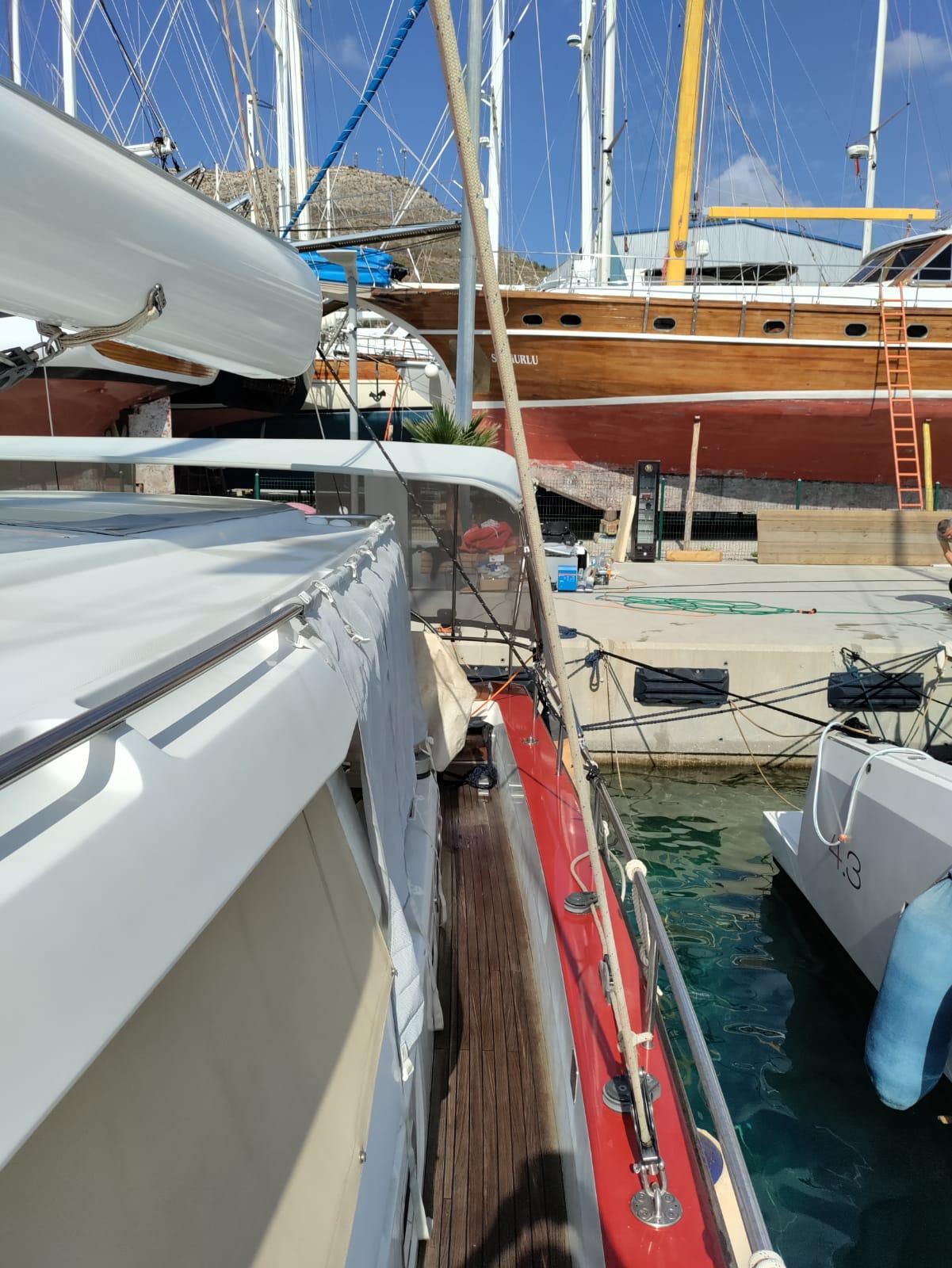 Sailboat docked at marina, Hanse 62 DS, 2011 model, with other boats in background.