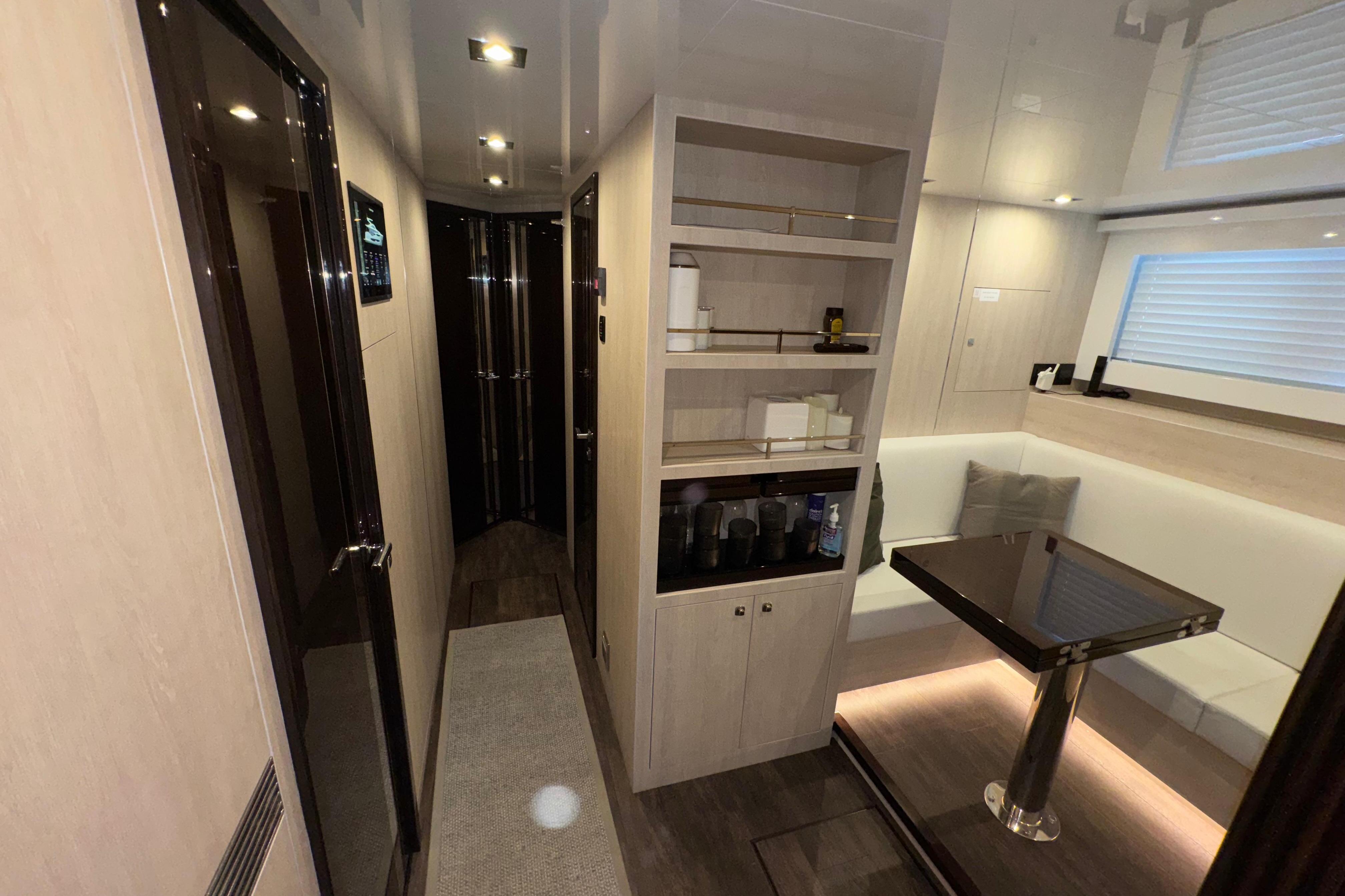 Luxurious interior of 2023 Pearl 95 yacht with modern furnishings and ambient lighting.