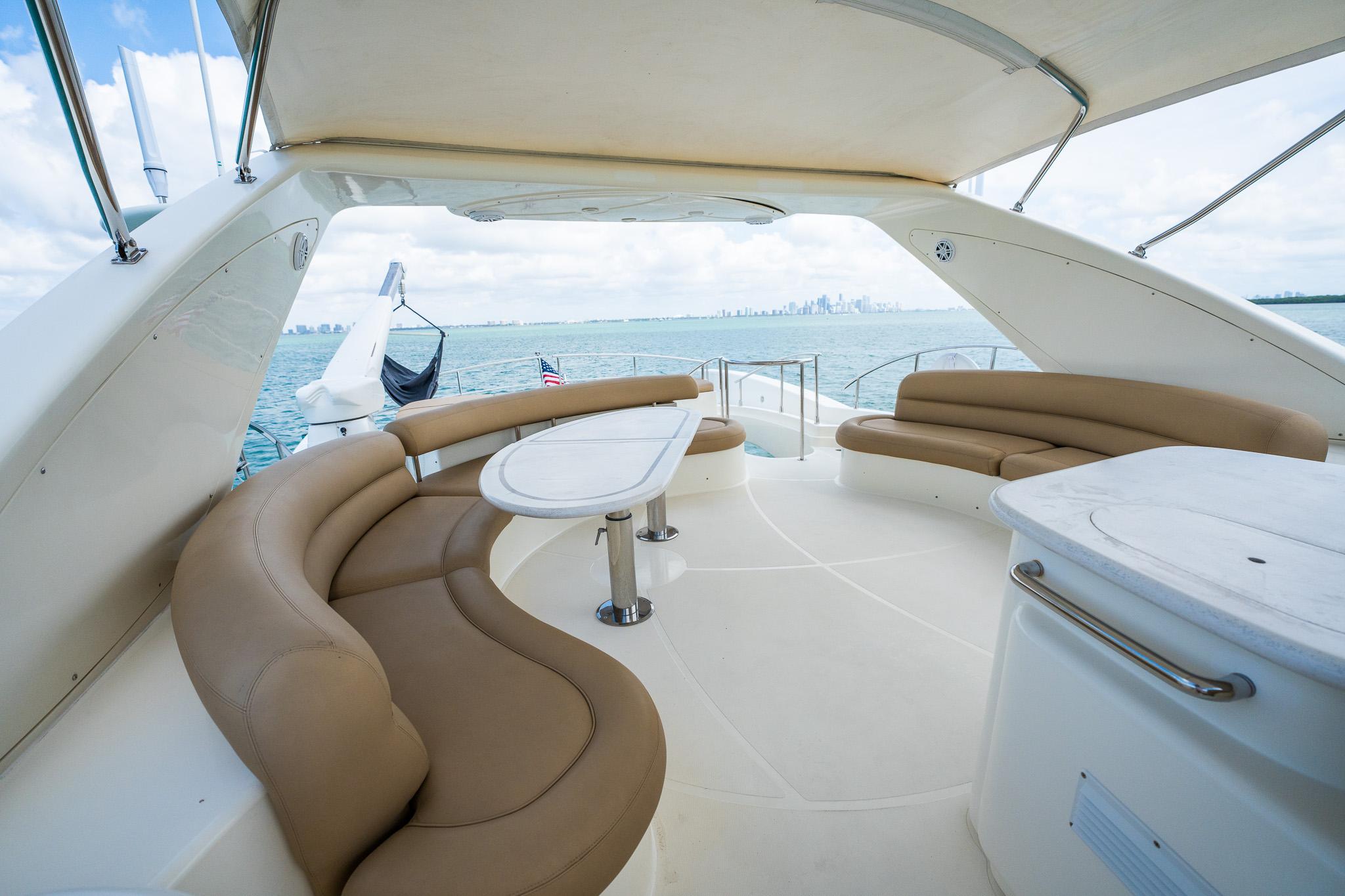 Luxurious 2004 Azimut 80 Carat yacht with spacious outdoor seating area.