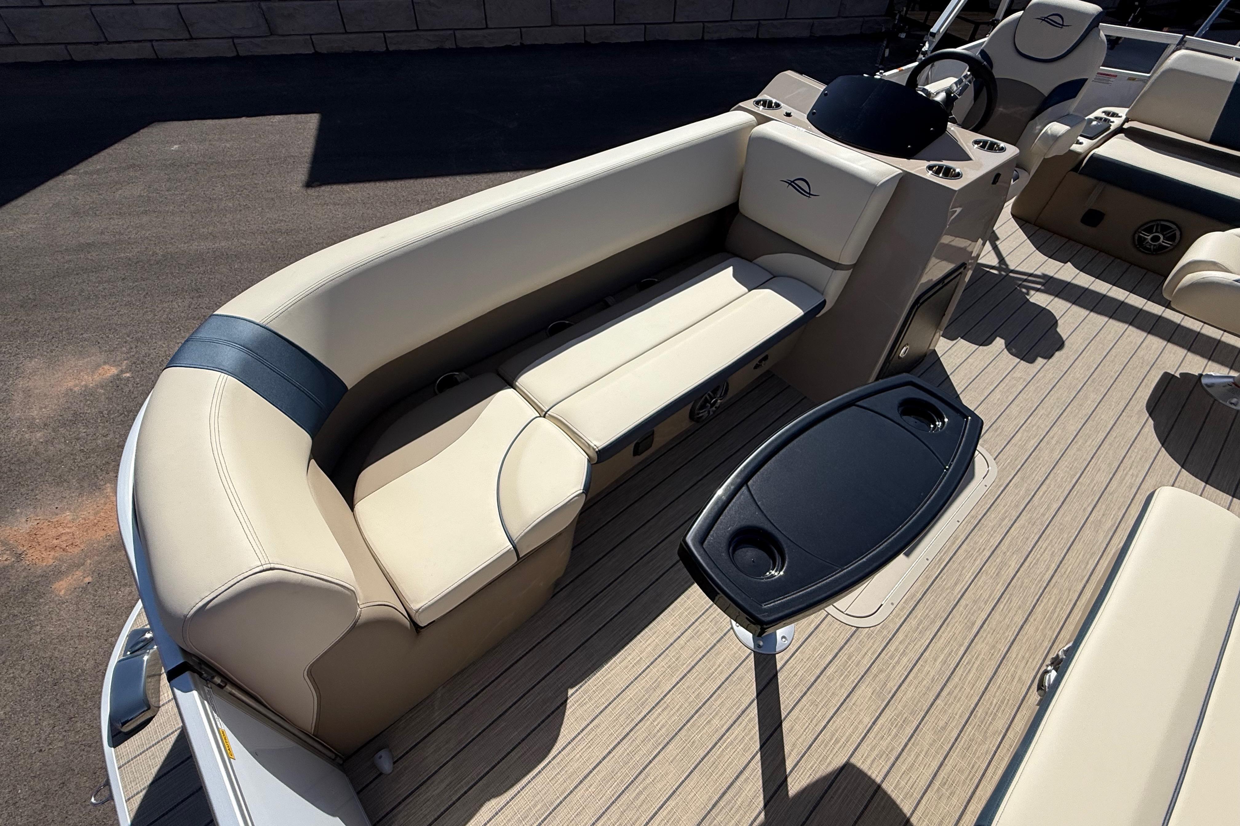 2026 SunCatcher Select 322SL boat interior with beige seating and black table.