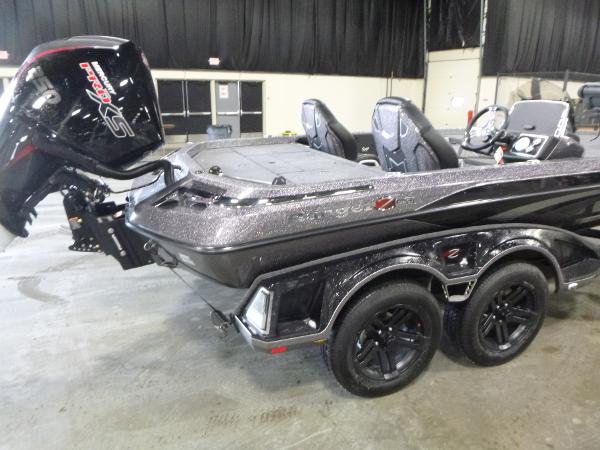 2025 Ranger Z520 boat with dual axles and powerful outboard motor in an indoor setting.