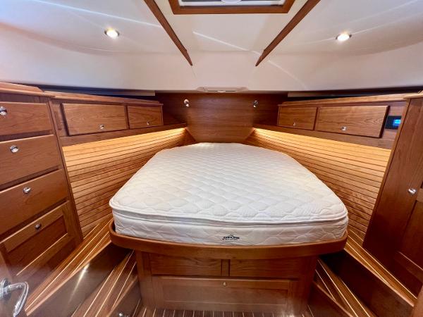 Luxurious 2025 Sabre 43 Salon Express cabin with elegant wood finish and cozy bed.