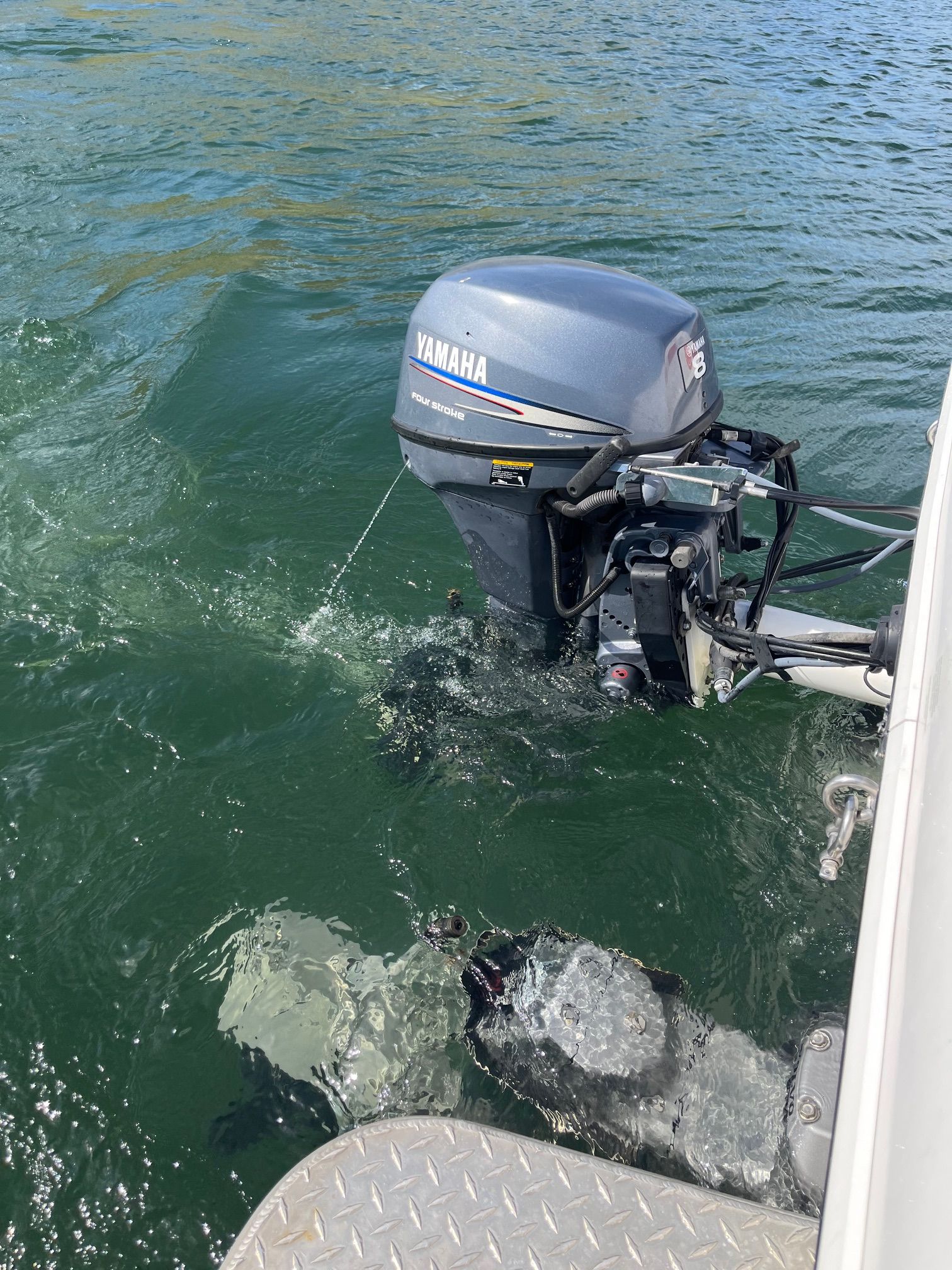 A Yamaha outboard motor on a boat in the water.
