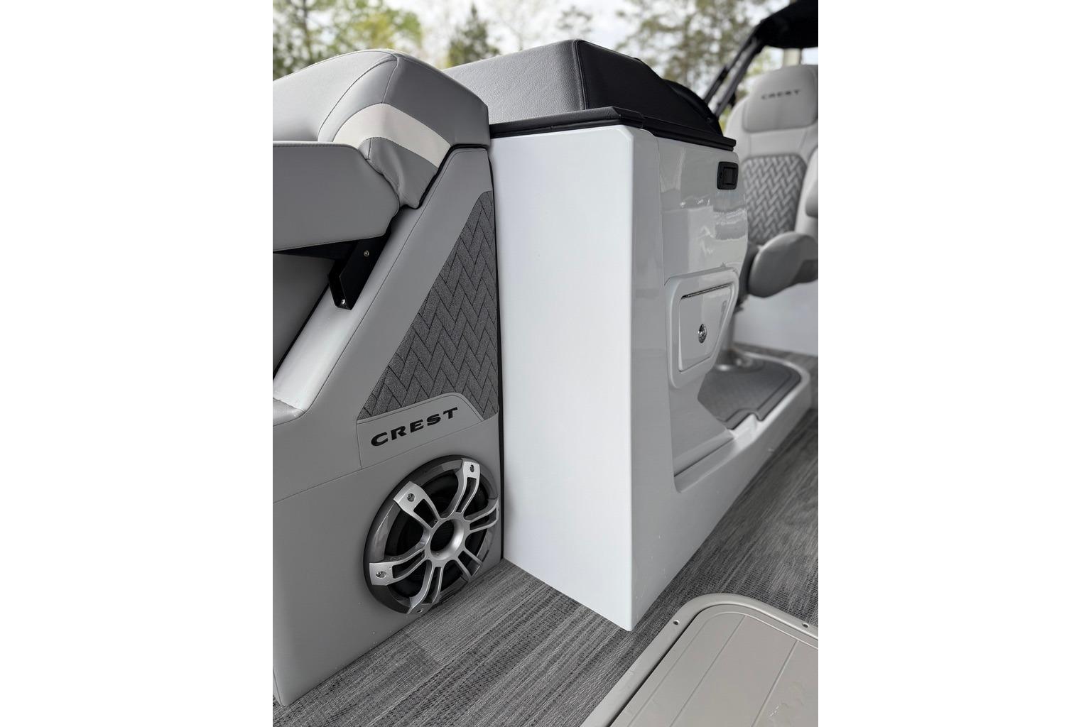 Interior of 2026 Crest Caribbean 250 SLRC boat, featuring sleek seating and speaker system.