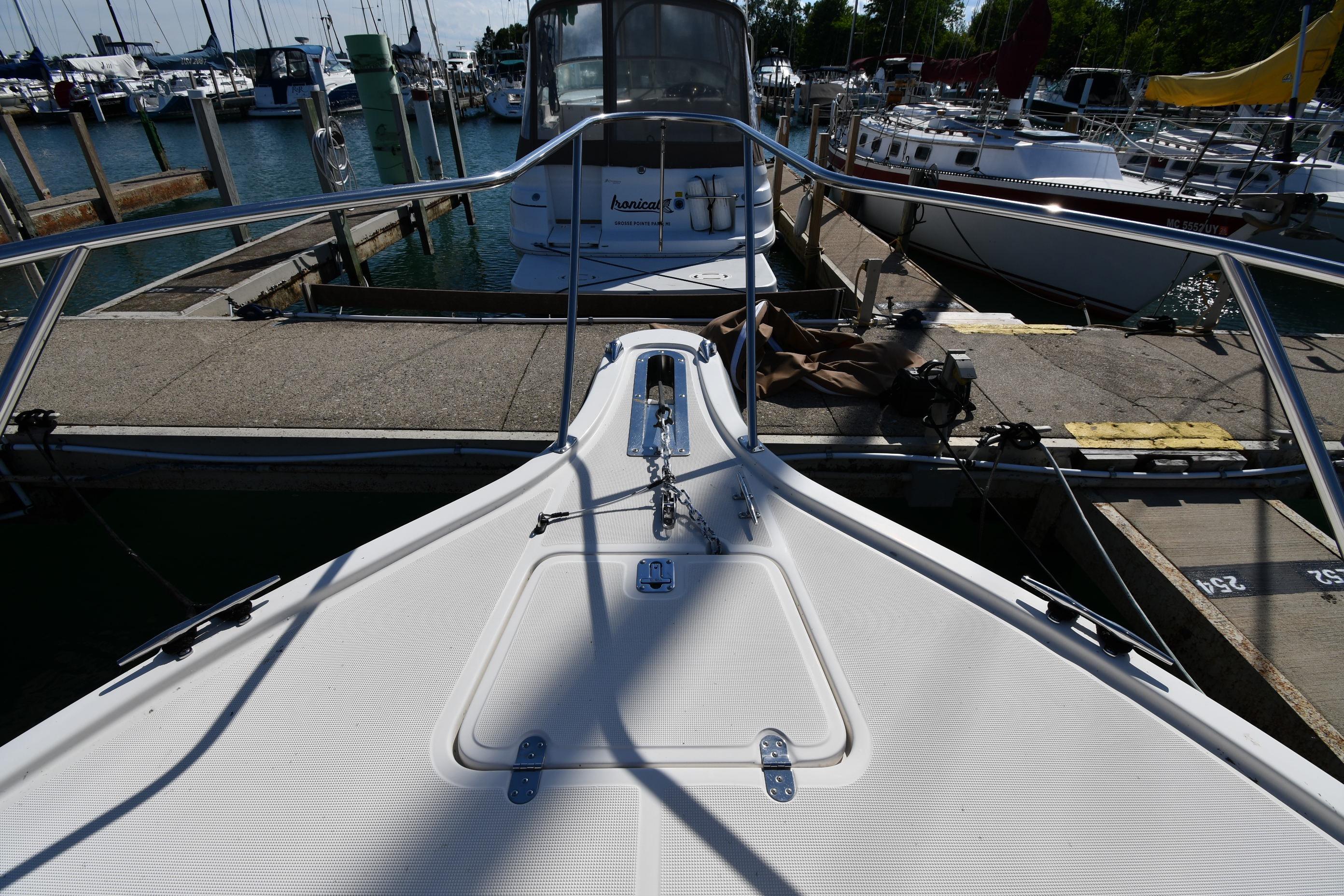 Bow view of a 1998 Tiara Yachts 3100 Open docked at a marina.