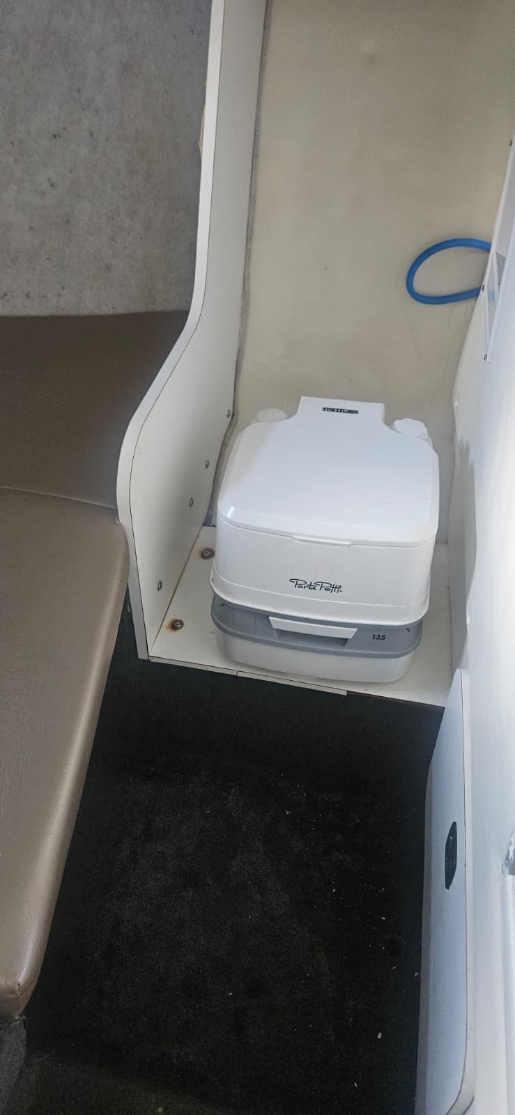 Interior of a 2000 Wellcraft 24 Walkaround with portable toilet.