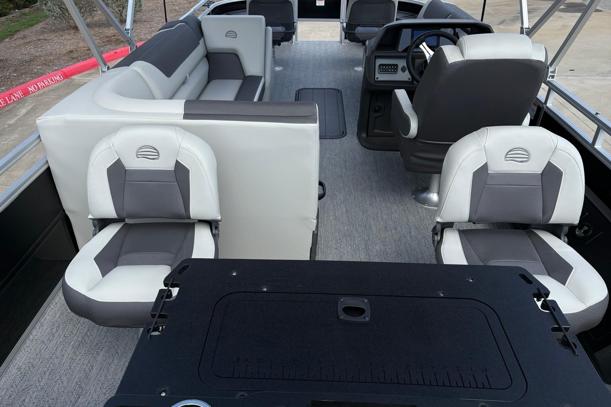 2026 Sun Tracker Fishin' Barge 22 XP3 interior with seating and steering console.