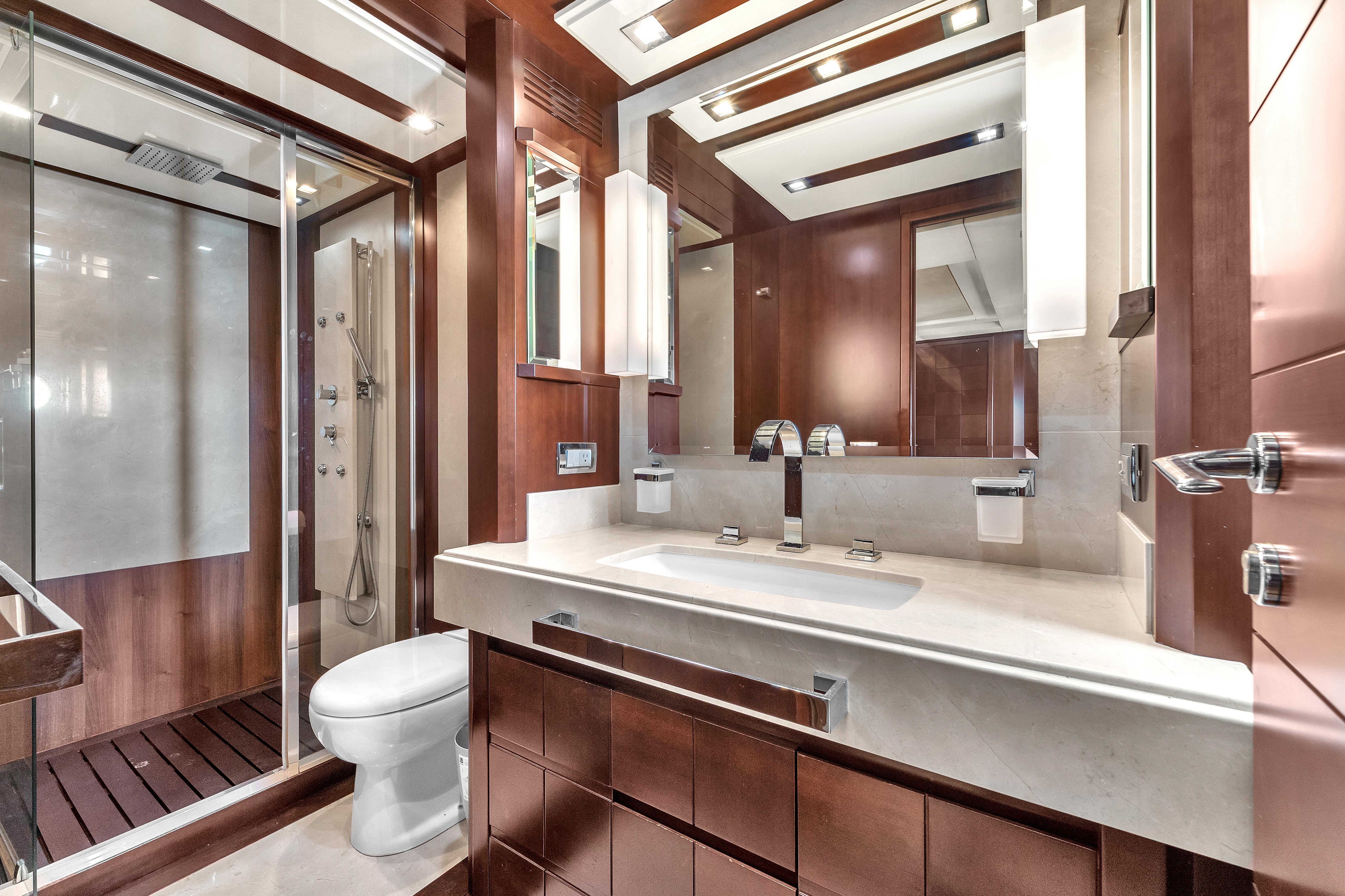 Luxurious bathroom interior on 2010 Azimut 95 yacht, featuring modern fixtures and elegant wood finishes.