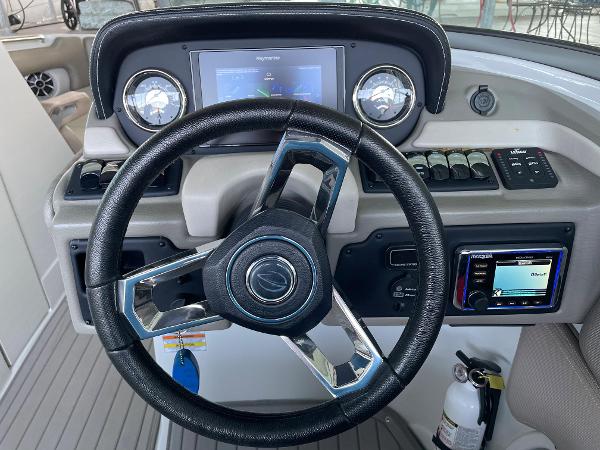 2019 Crownline E255 boat dashboard with steering wheel and control panel.
