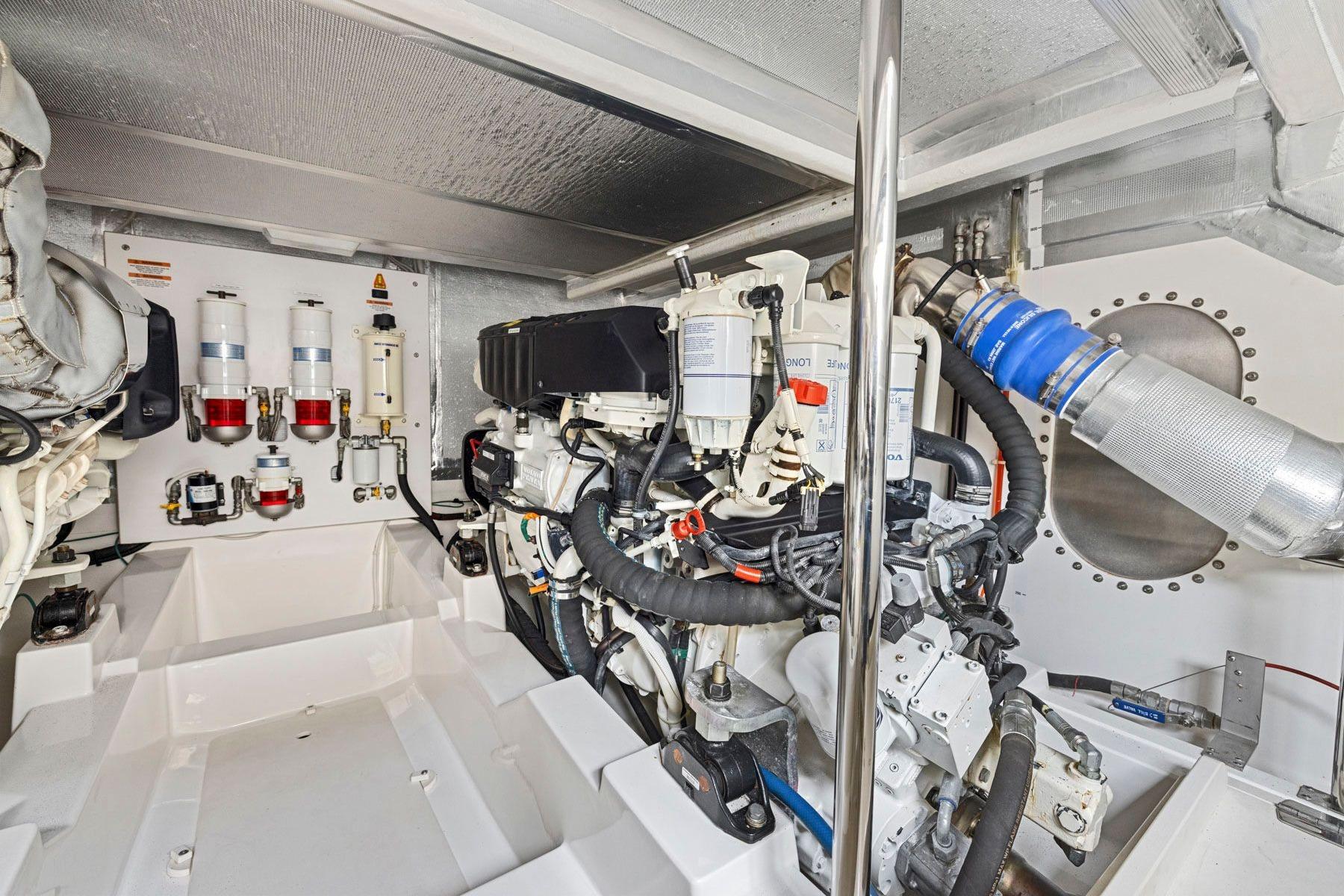 Engine room of 2014 Maritimo M50 yacht, showcasing mechanical components and systems.