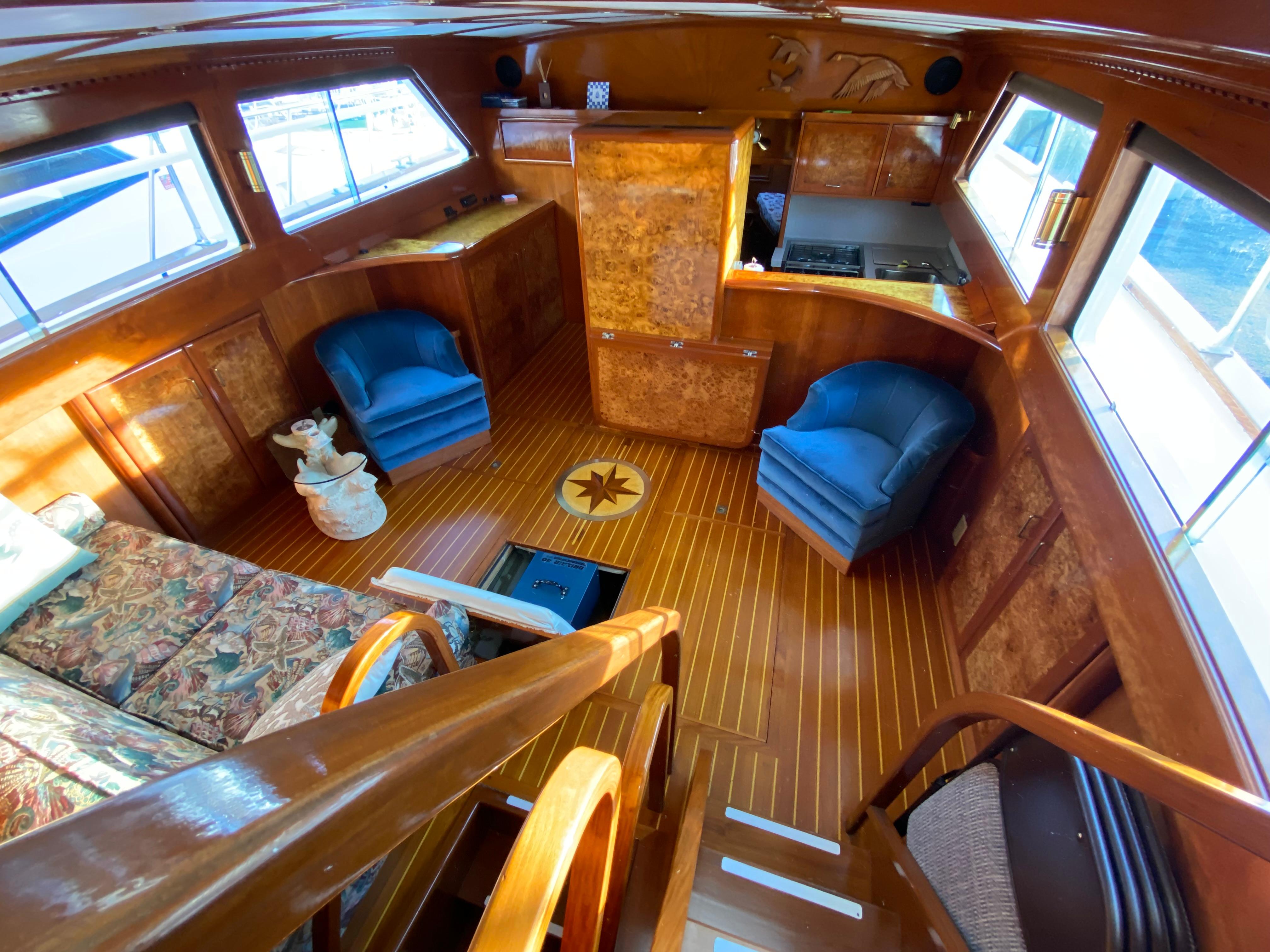 1971 Matthews Custom Pilothouse Motor Yacht interior with wood finish and blue chairs.