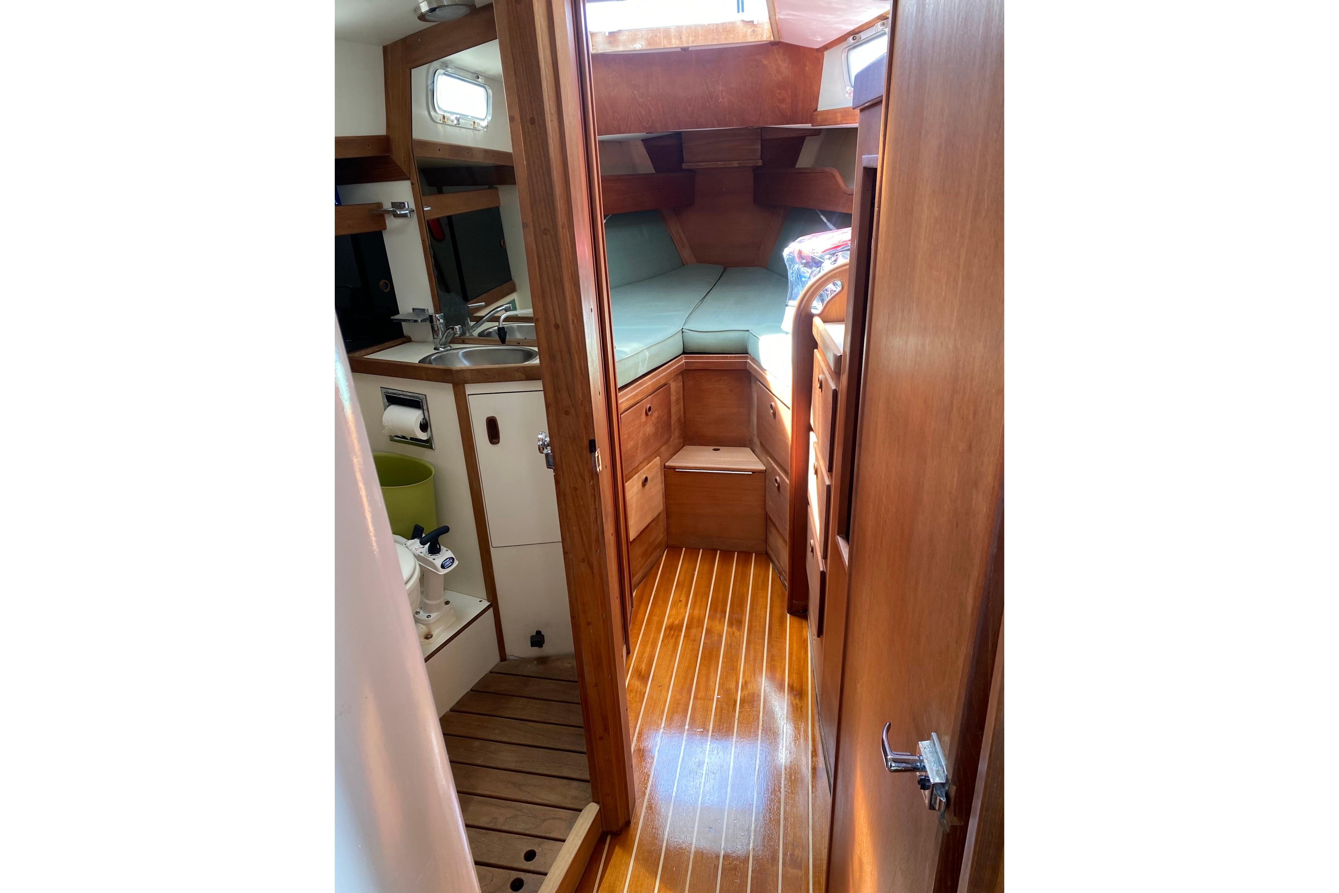 Interior of 1984 Sabre MK 1 sailboat with wooden cabinetry and compact layout.