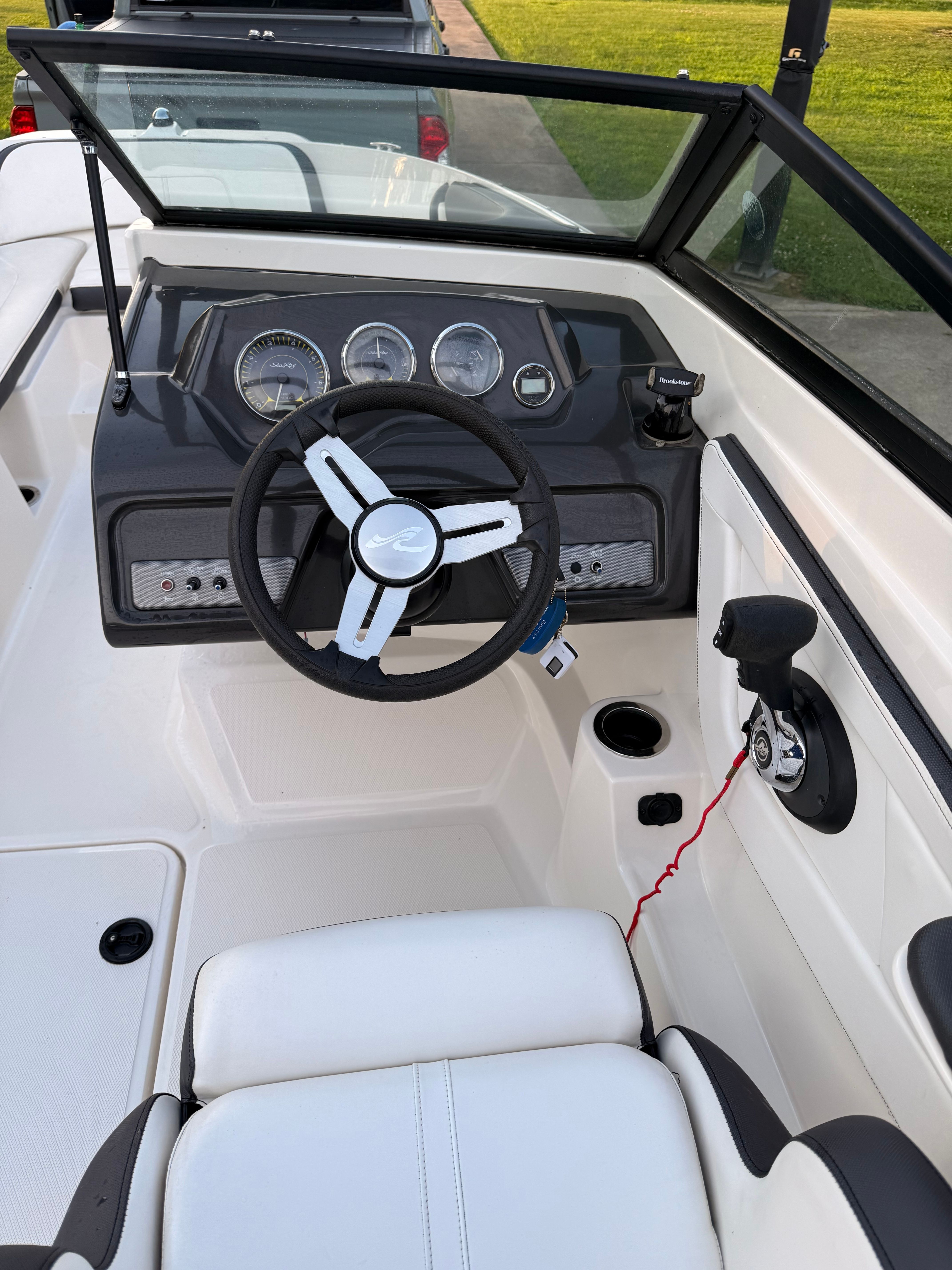 The image shows the cockpit of a 2016 Sea Ray SPX 210 Outboard with a modern helm.