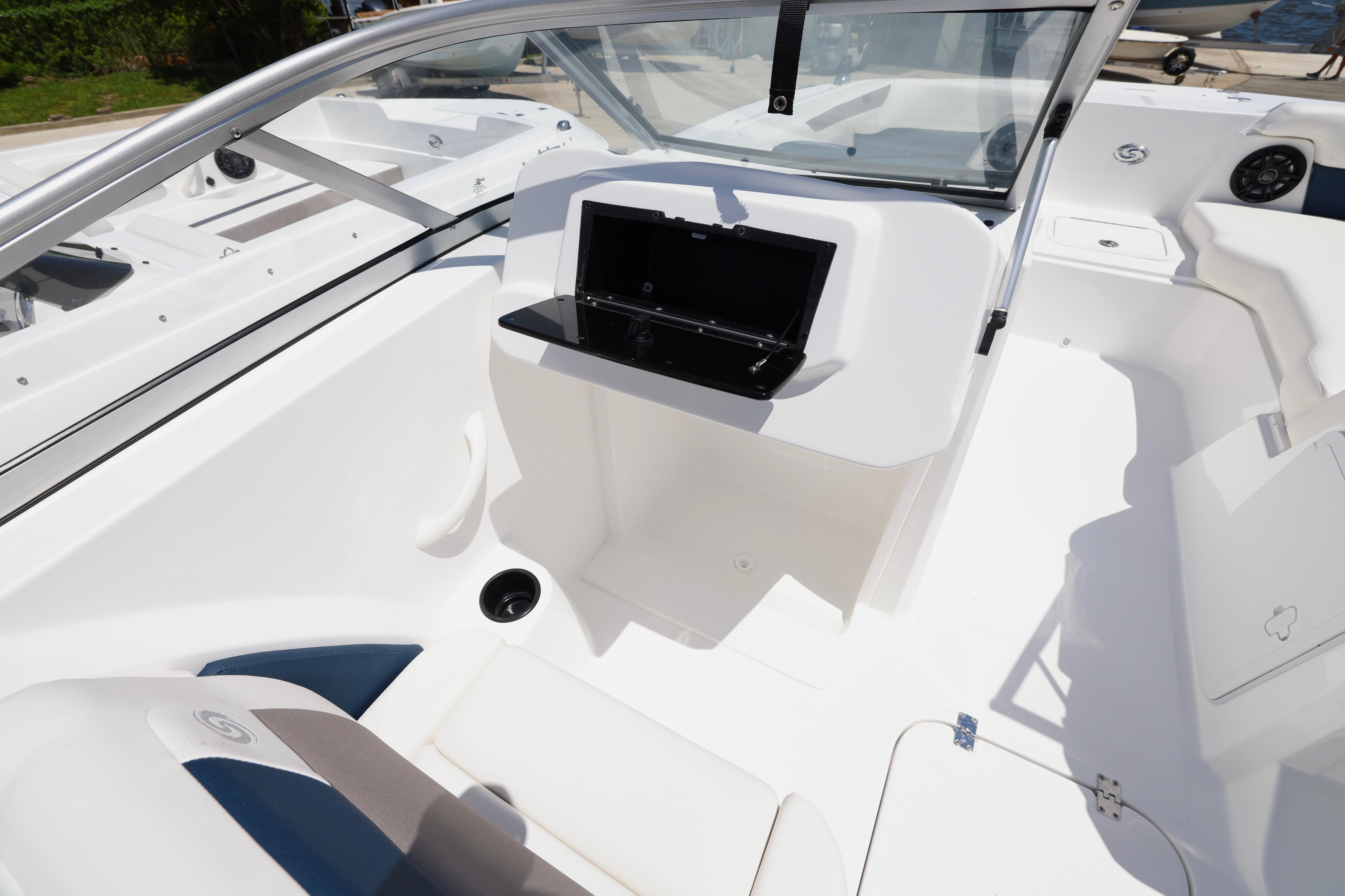Interior of 2026 Hurricane SunDeck 2050 OB boat, featuring sleek white seating and modern design.