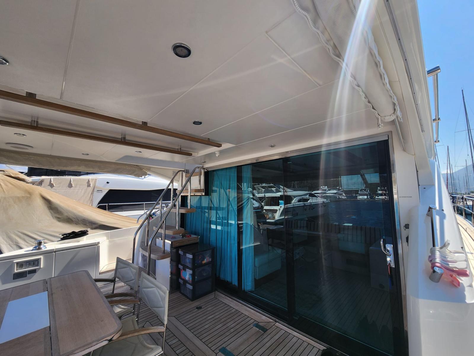 2012 Fairline Squadron 65 yacht deck with seating and glass doors.
