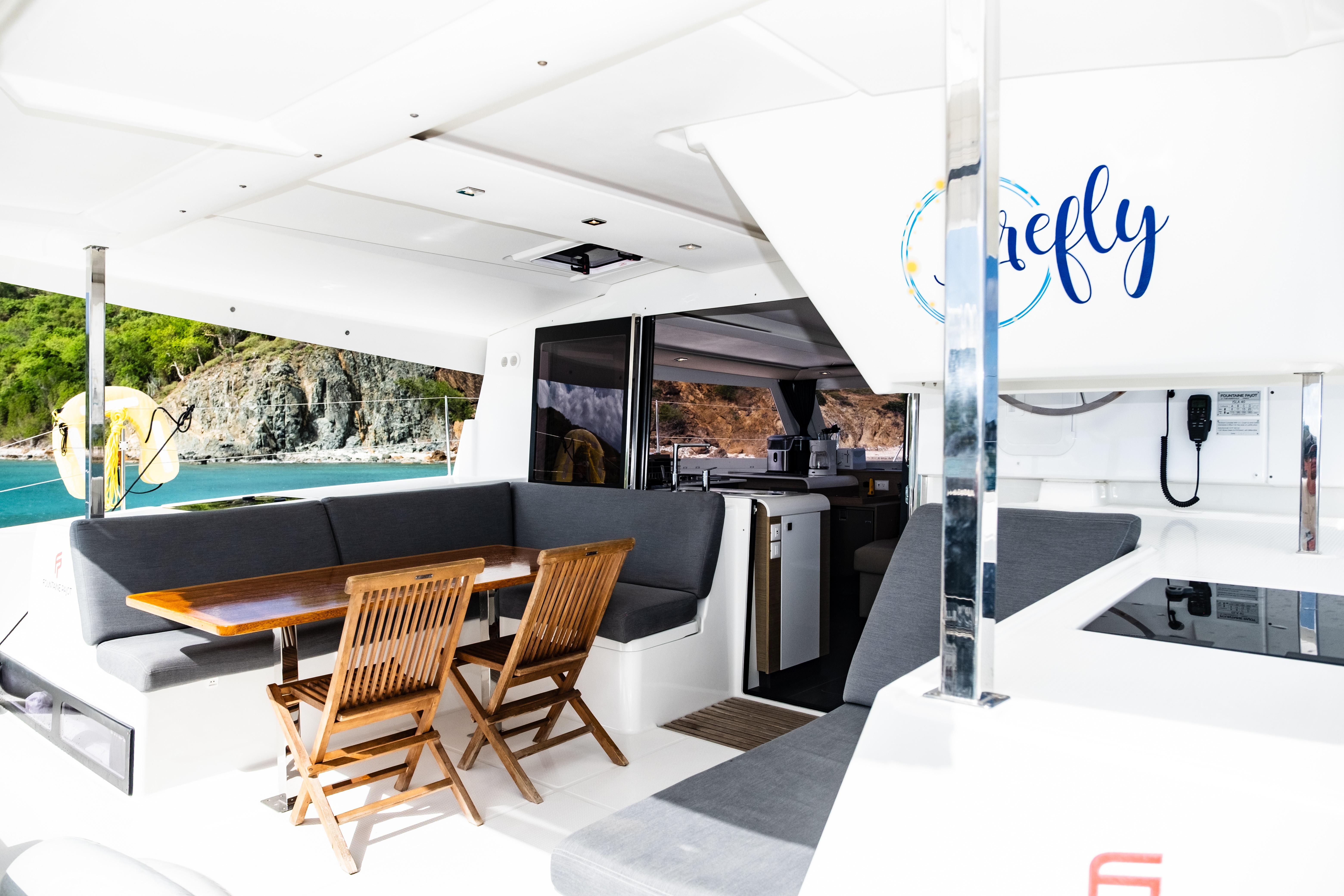 Luxurious 2023 Fountaine Pajot Isla 40 catamaran interior with elegant seating and dining area.