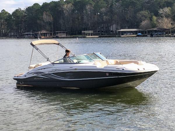2012 Godfrey Hurricane boat on a calm lake.