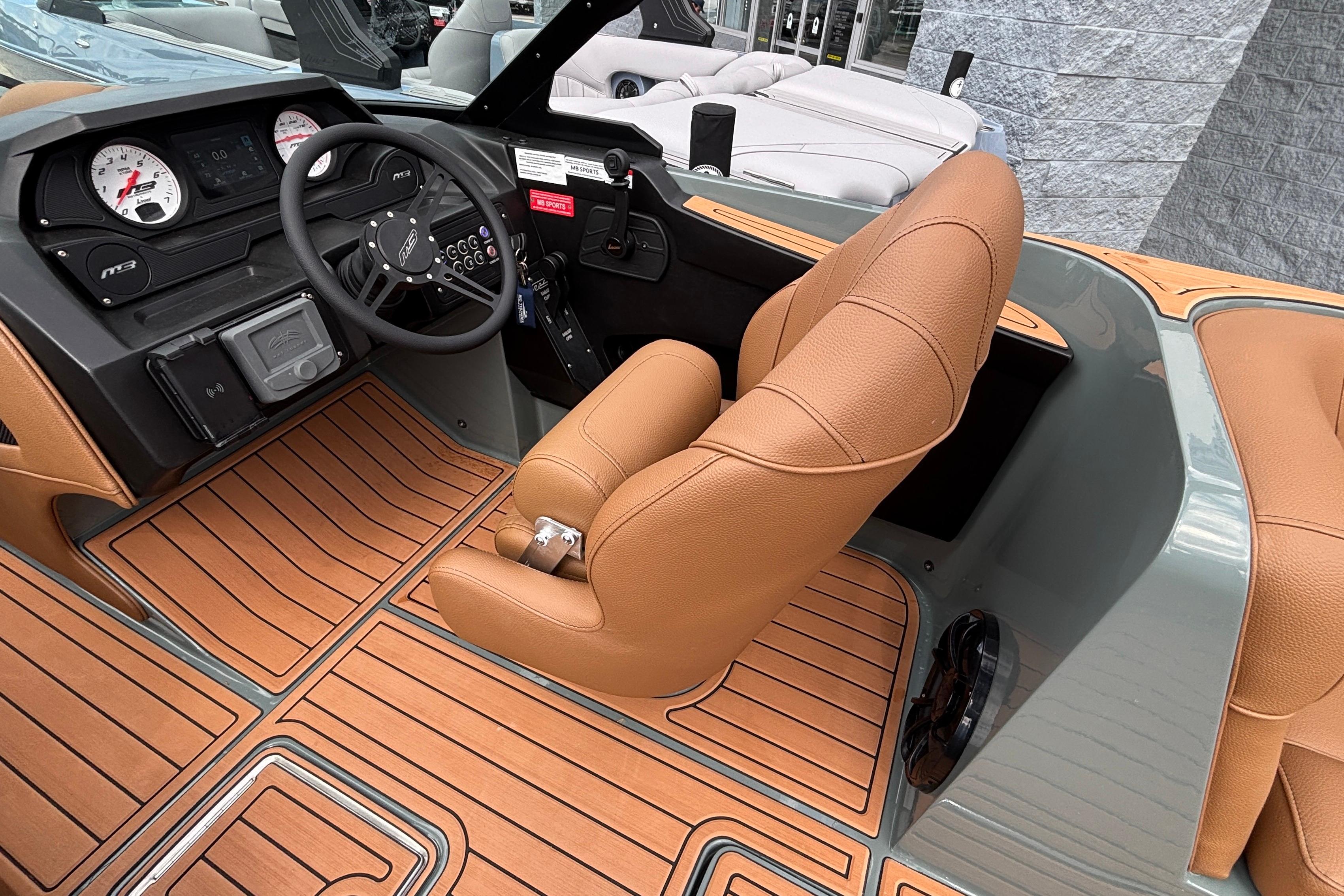 2026 MB B52 23 Classic boat interior with tan leather seats and wood-patterned flooring.