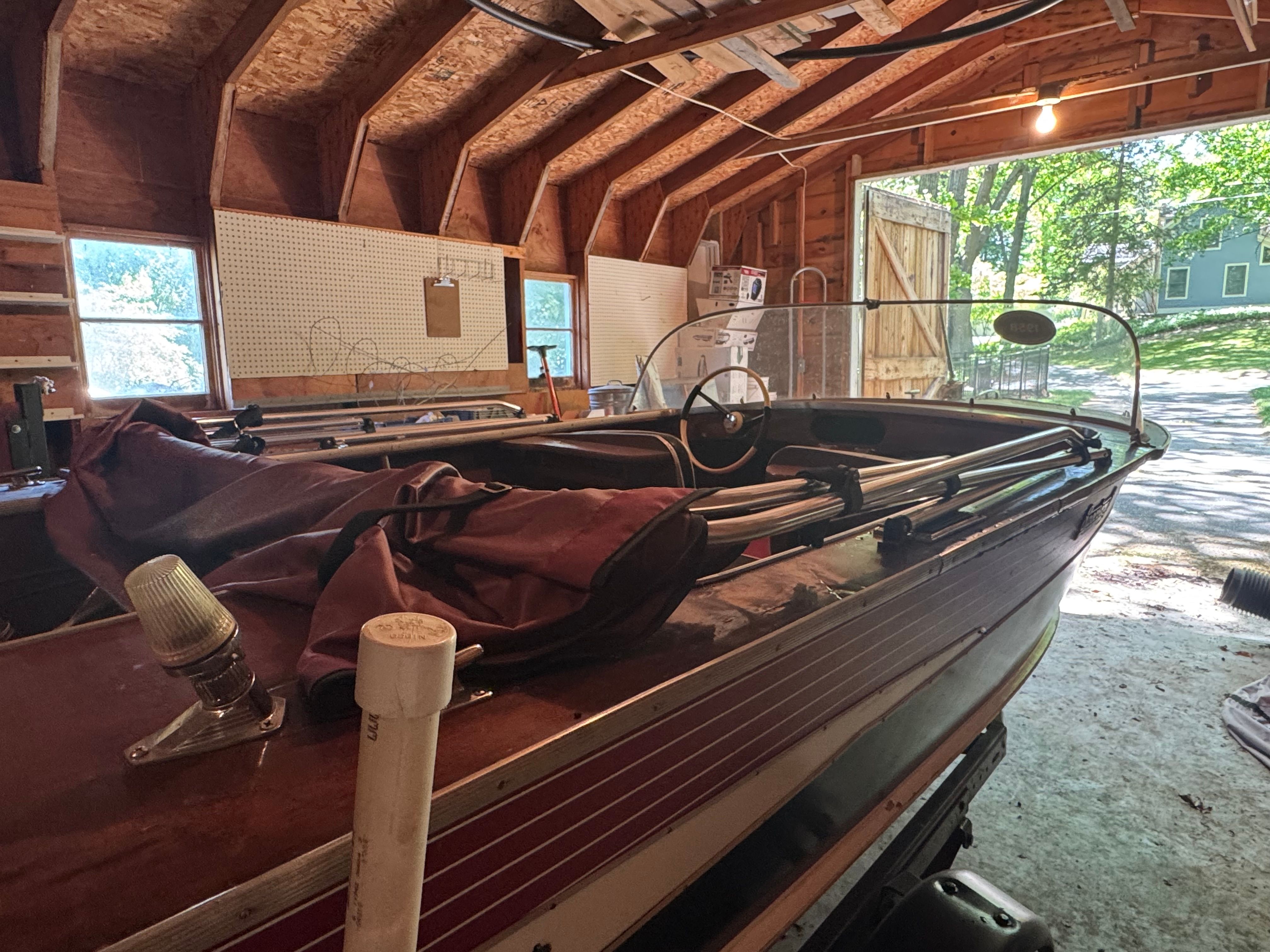 1958 Classic Sportcraft Runabout in a wooden garage.