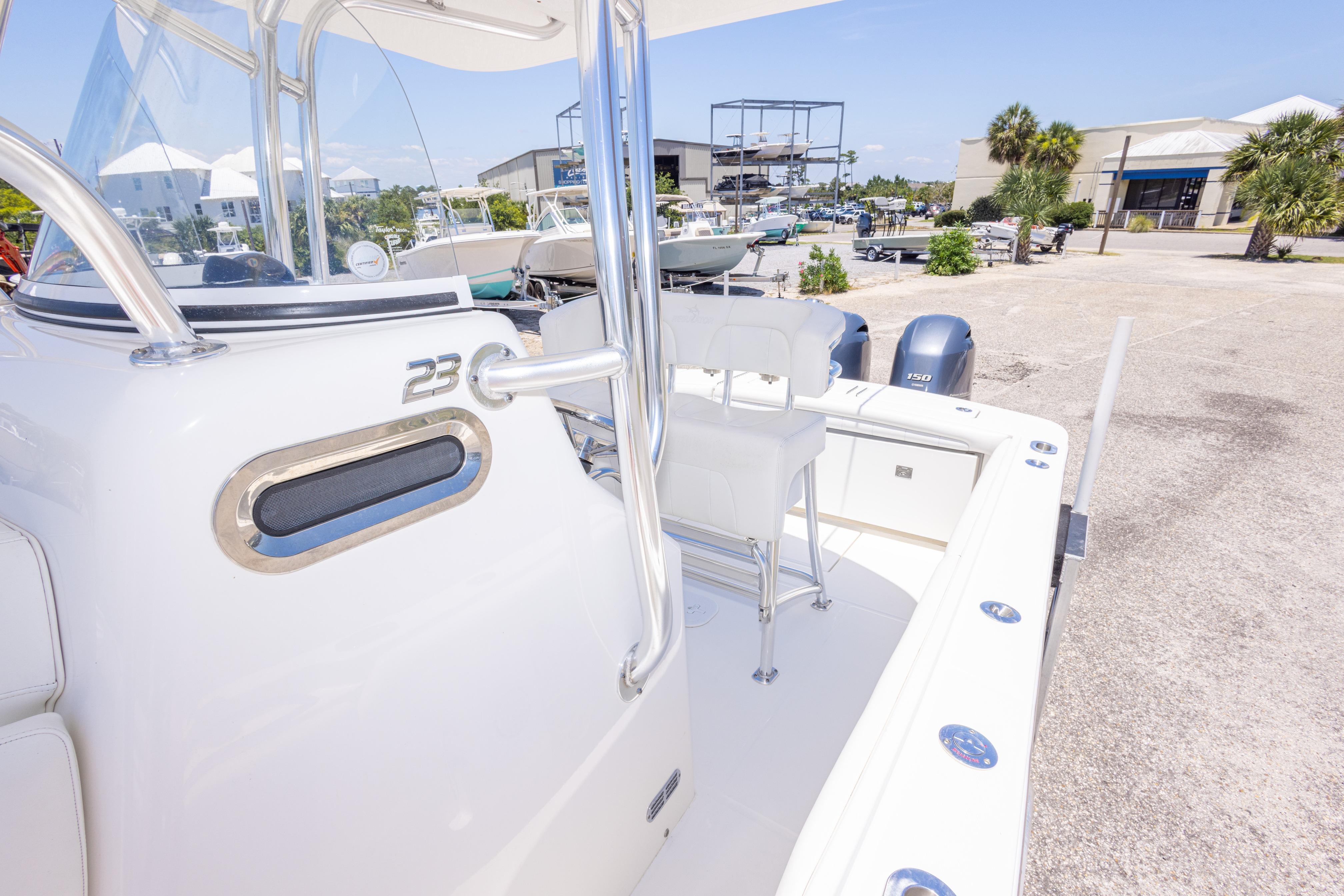 2019 Regulator 23 Center Console boat docked, showcasing sleek design and dual engines.