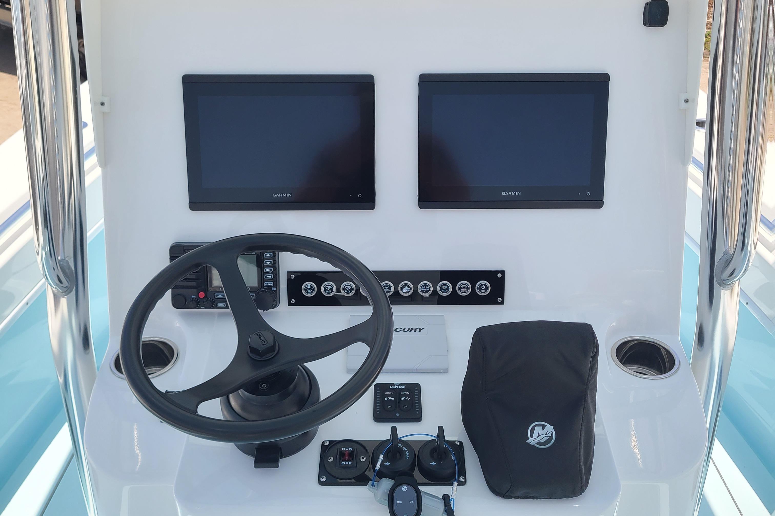 2023 Contender 25 Tournament boat dashboard with dual screens and steering wheel.