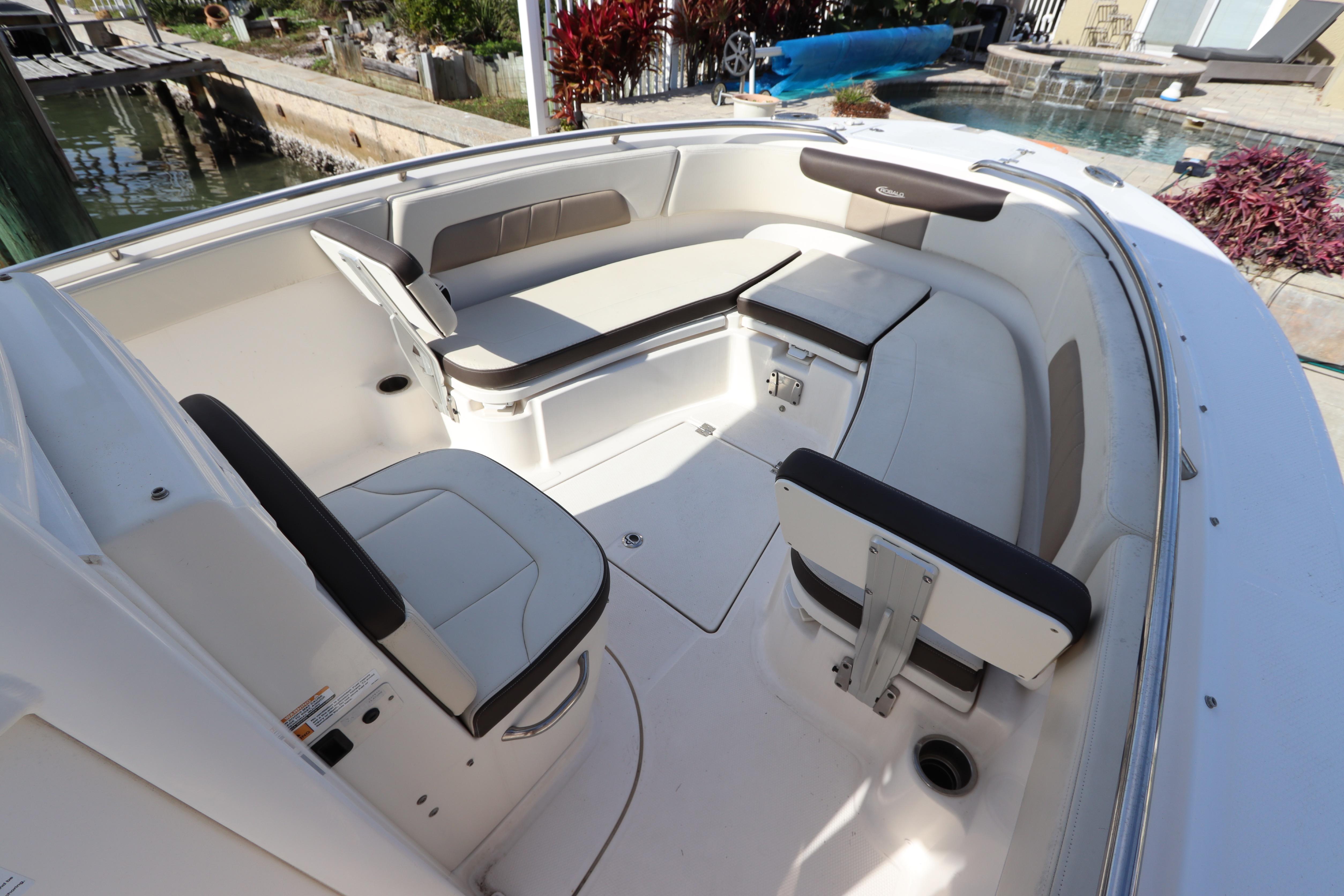 2019 Robalo R242 Center Console boat interior with cushioned seating and storage compartments.
