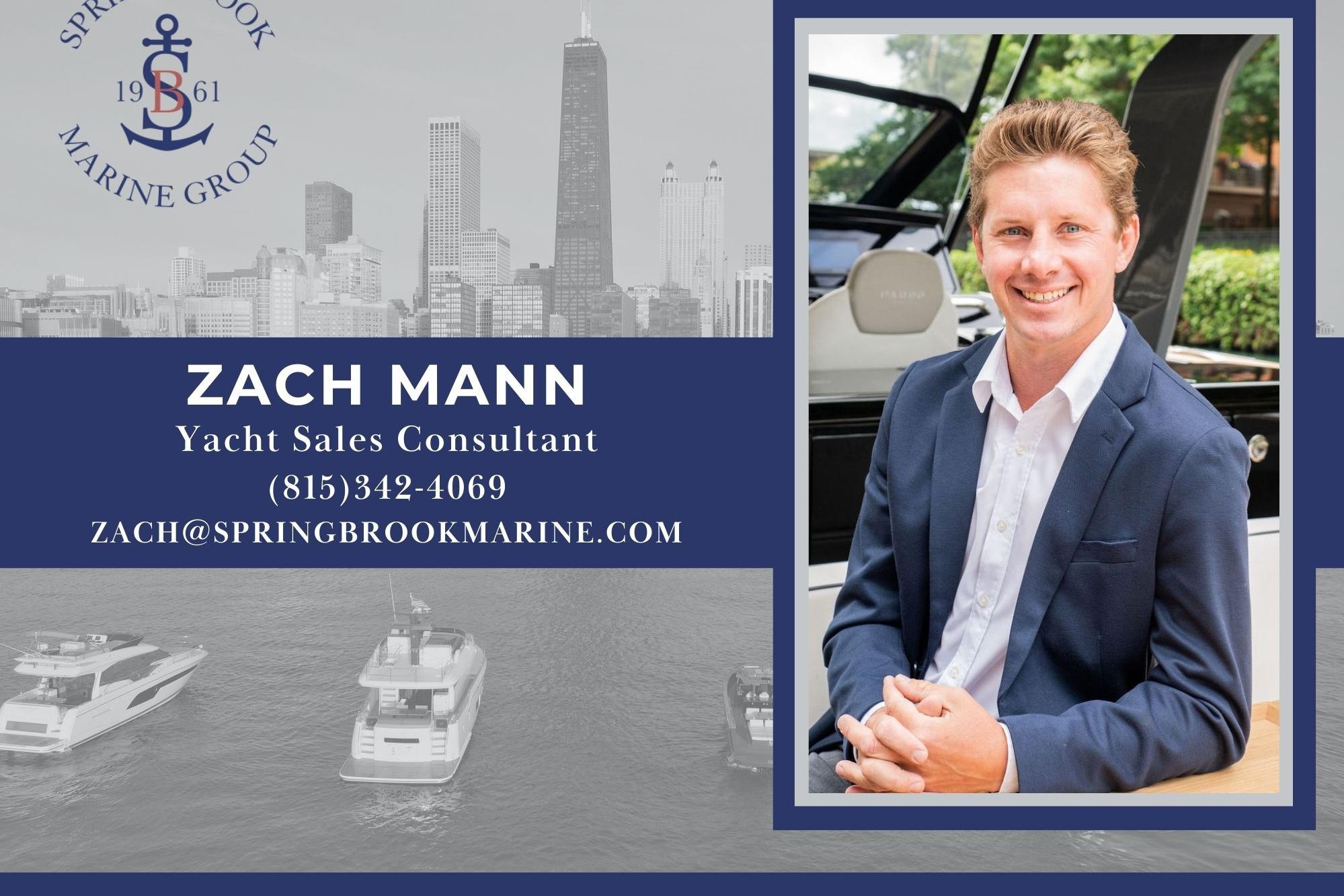 Zach Mann, yacht sales consultant, contact details, Spring Brook Marine Group, city skyline background.