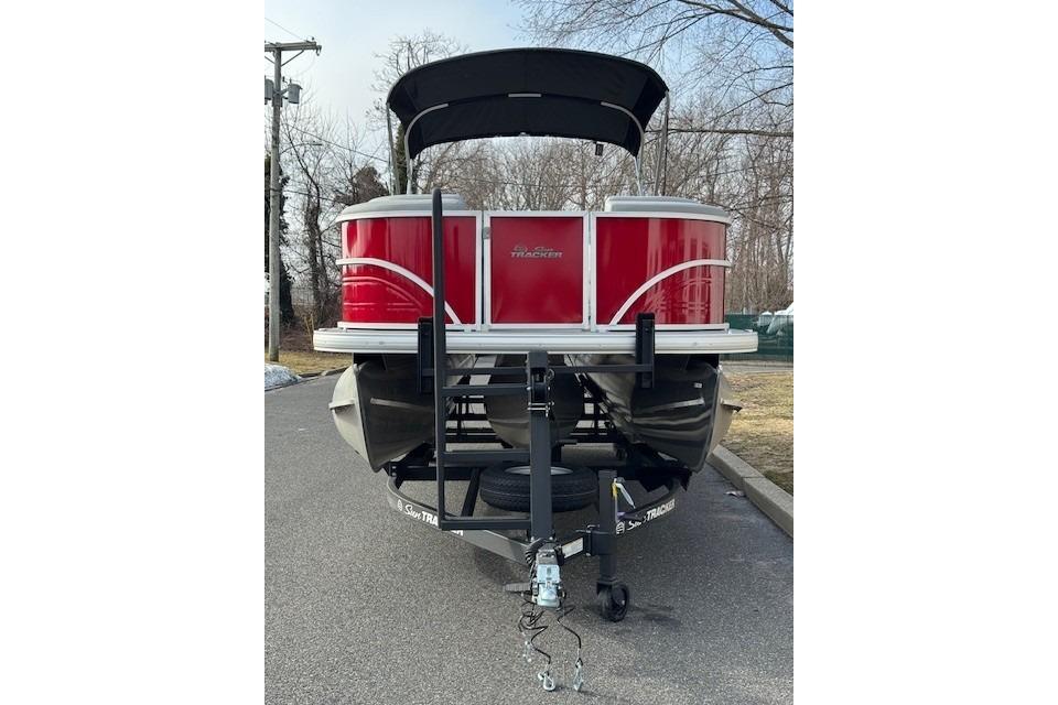 2026 Sun Tracker Party Barge 24 XP3 pontoon boat on trailer, parked outdoors.