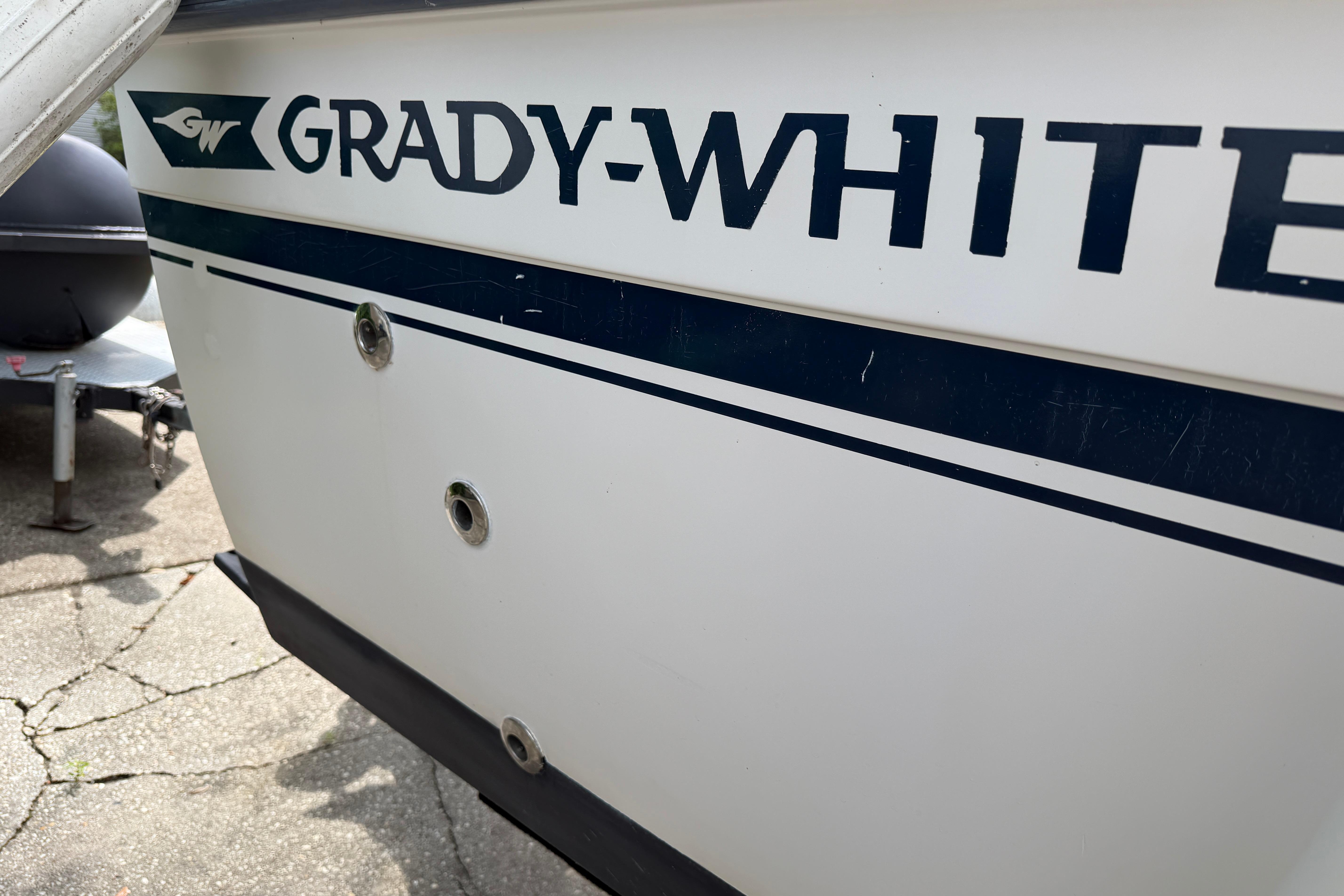 1987 Grady-White Seafarer 226 boat hull with logo and blue stripe detail.