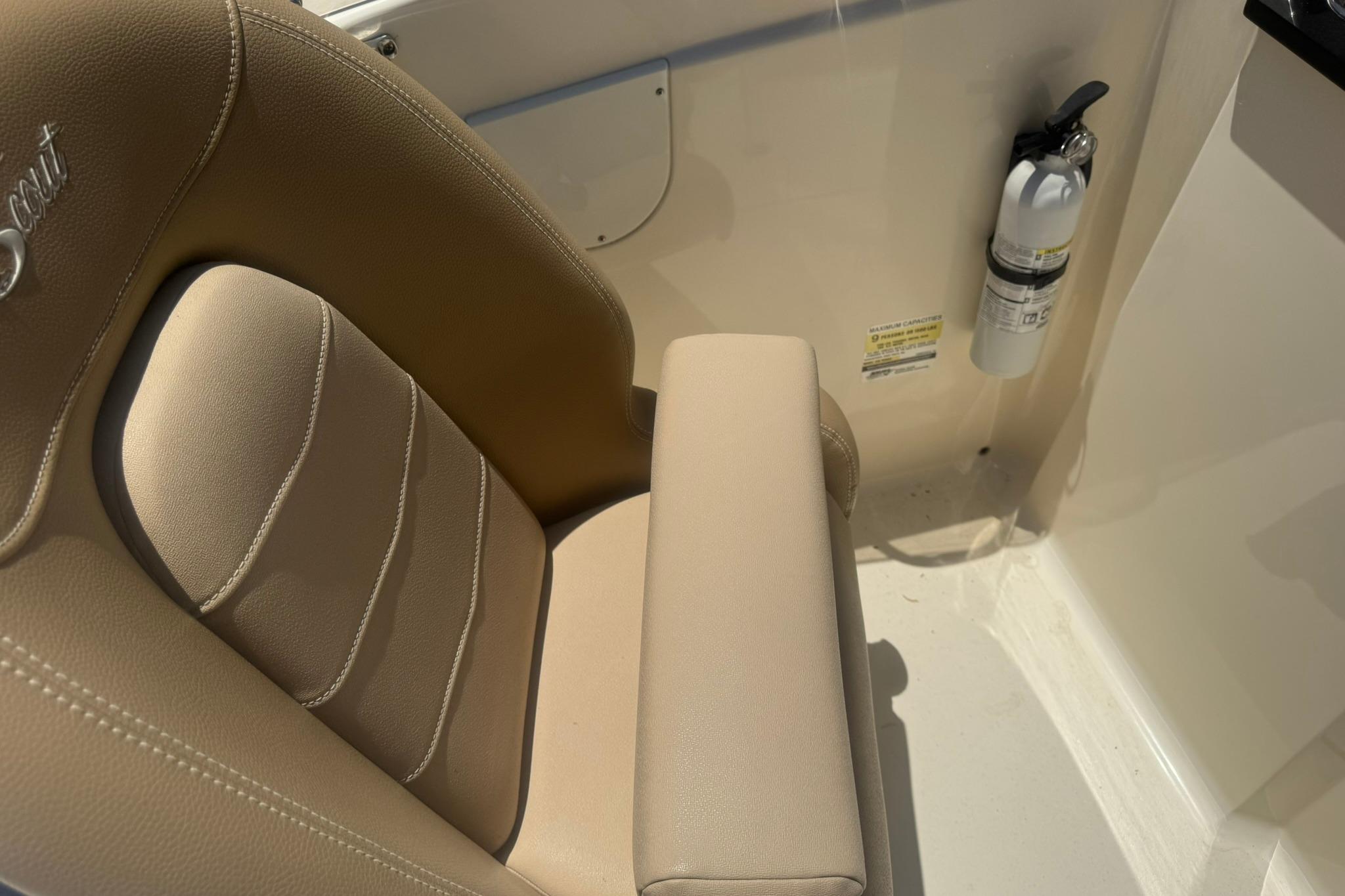 2021 Scout 215 Dorado boat seat with beige upholstery and mounted fire extinguisher.