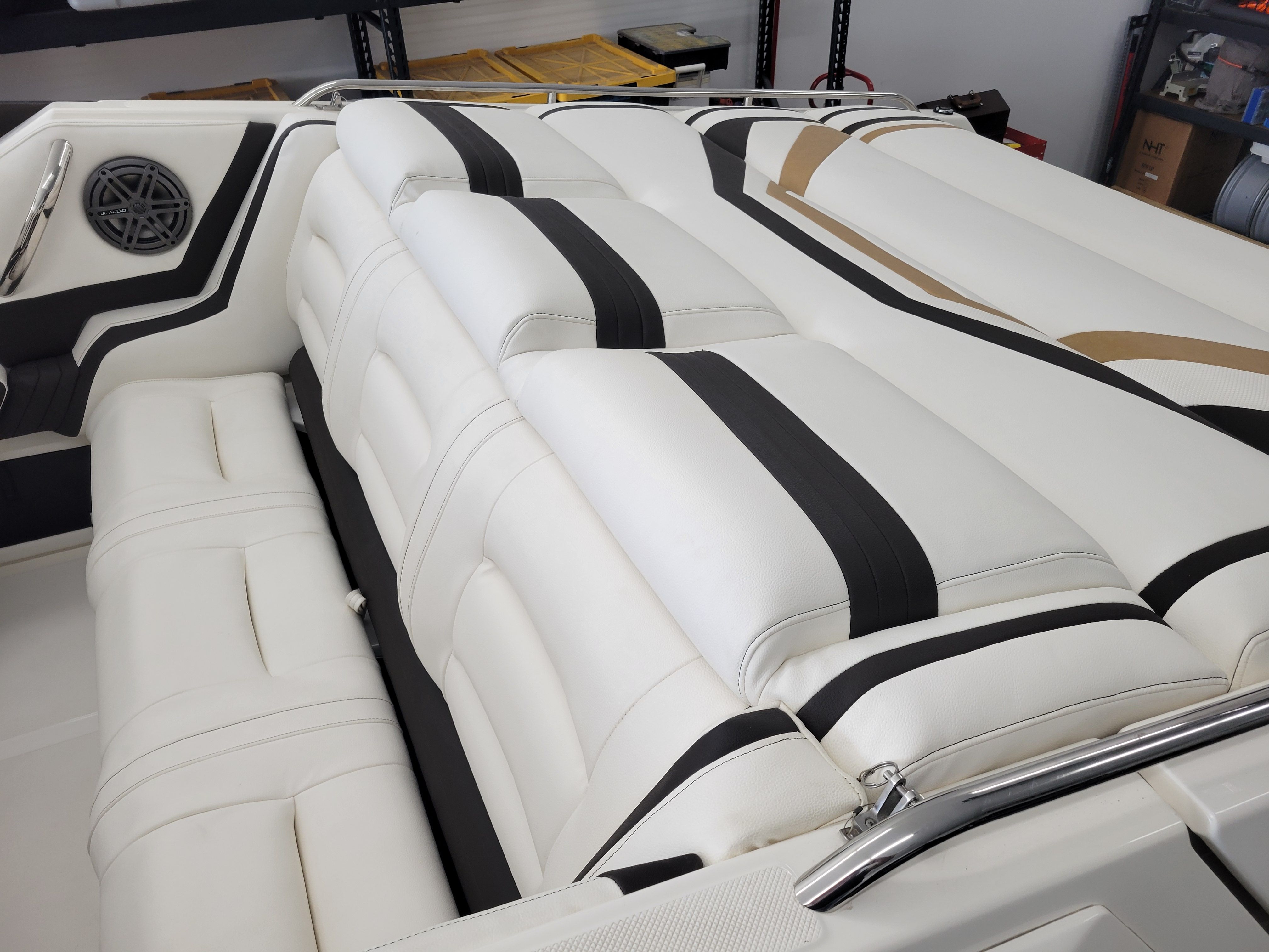 Luxurious white seating with black accents in a 1992 Fountain Fever boat interior.