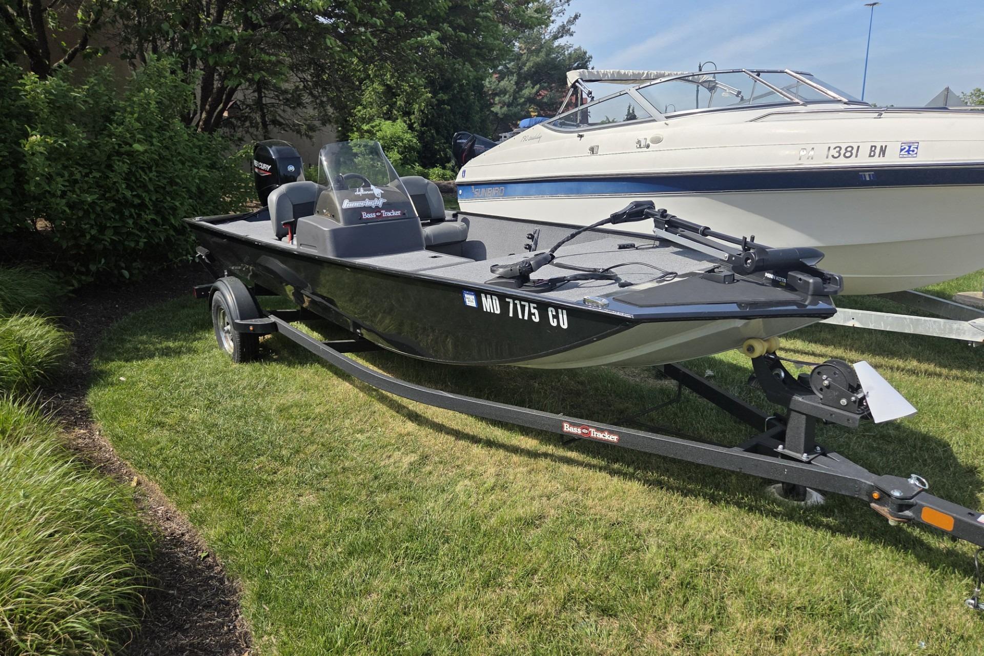 2024 TRACKER MARINE CLASSIC XL boat on trailer, parked on grass.