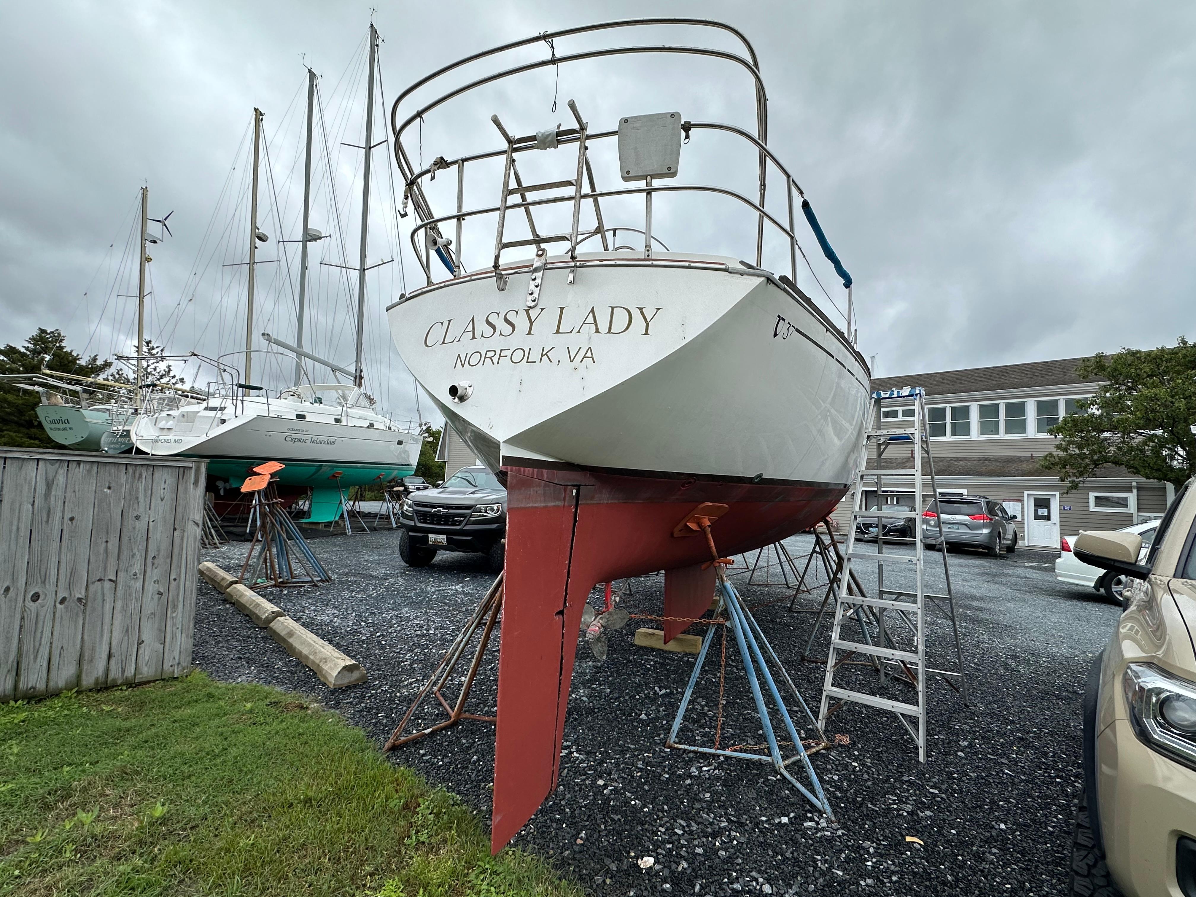1981 Tartan 37 sloop "Classy Lady" on land in Norfolk, VA, with overcast sky.
