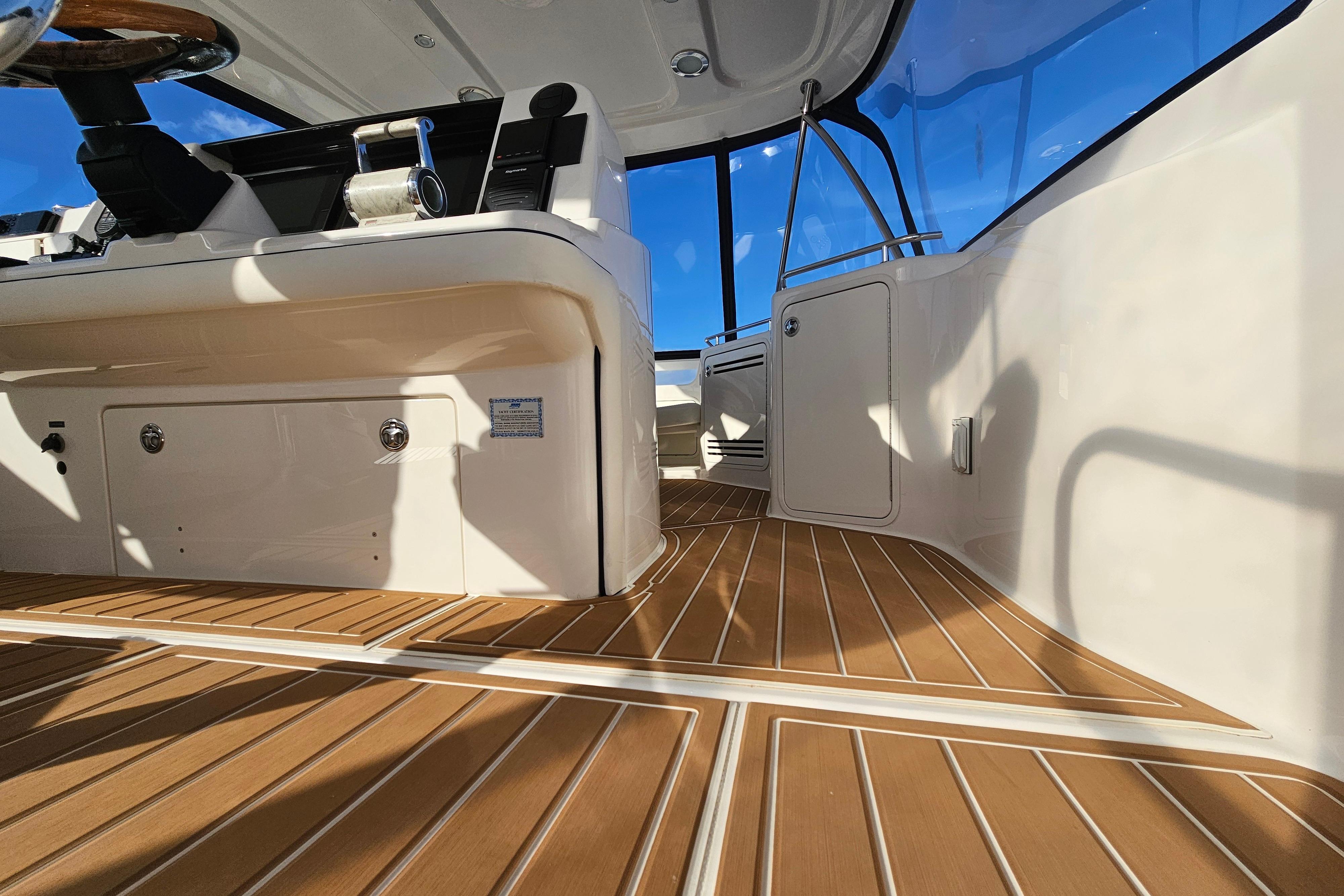 Interior view of 2006 Sea Ray 580 Sedan Bridge with sleek wooden flooring.