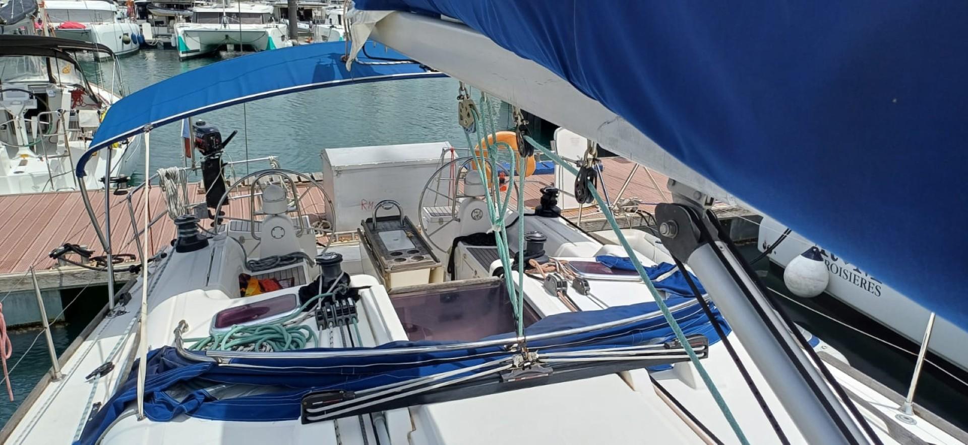 Dufour 455 Grand Large 2008 sailboat docked at marina, featuring dual steering wheels.