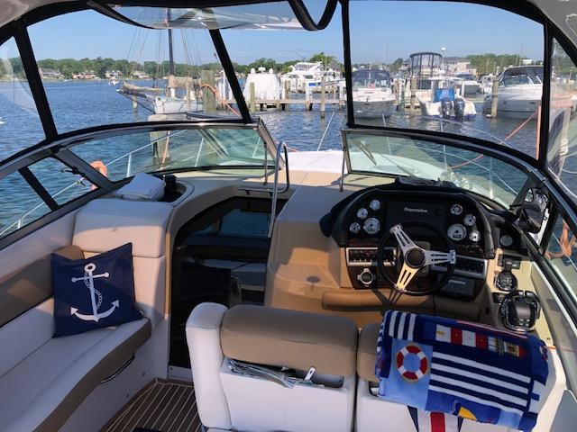 2014 Four Winns 355V boat interior with helm, seating, and marina view.